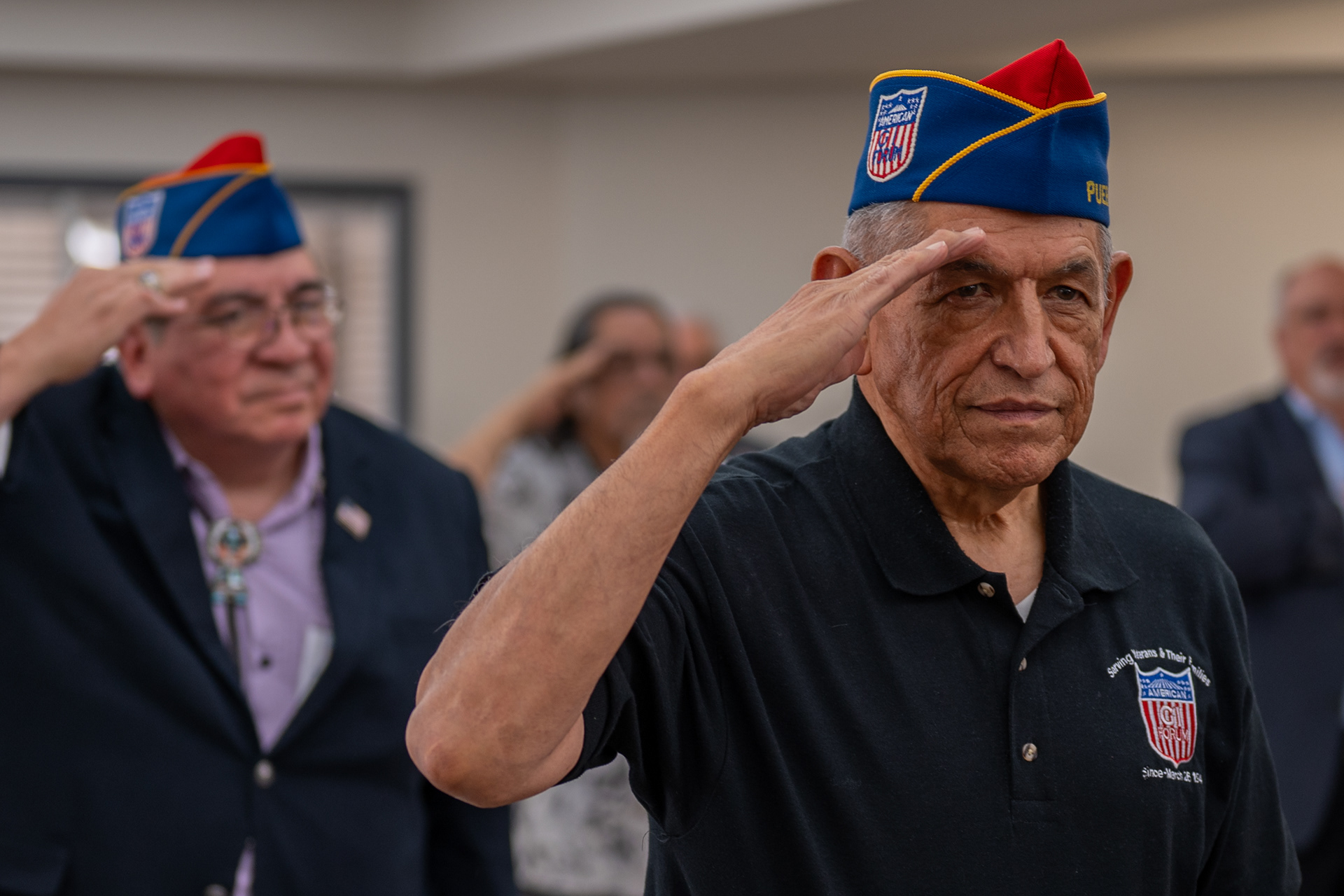 American GI Forum national treasurer Ted Lopez salutes during the national anthem at the Valor Hill Apartments ribbon-cutting on July 29, 2025, in San Antonio.