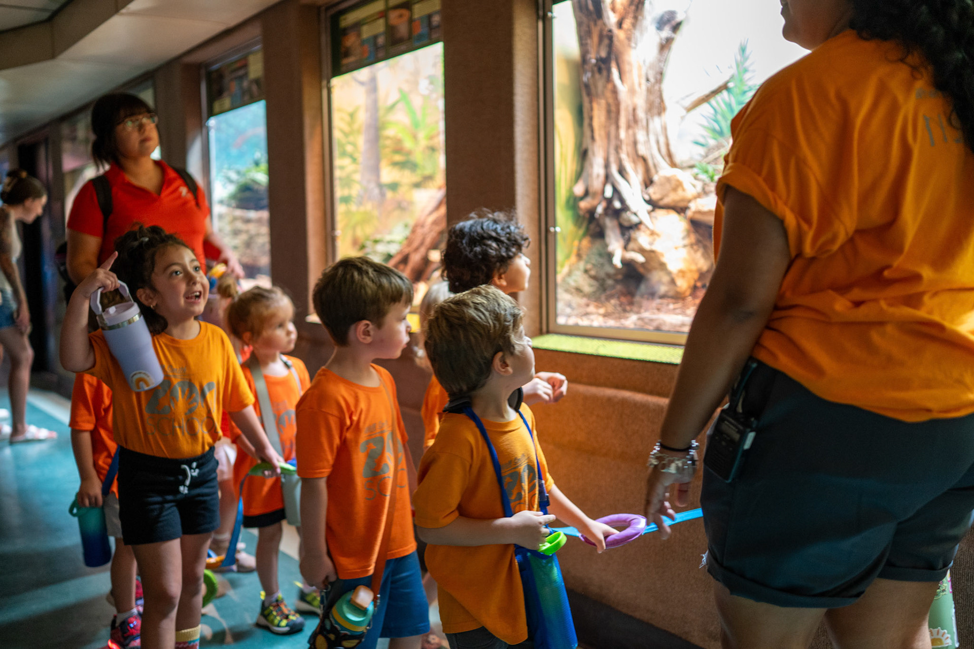 Children walk through the Reptile House at the San Antonio Zoo during a lesson with the Will Smith Zoo School on June 17, 2025.