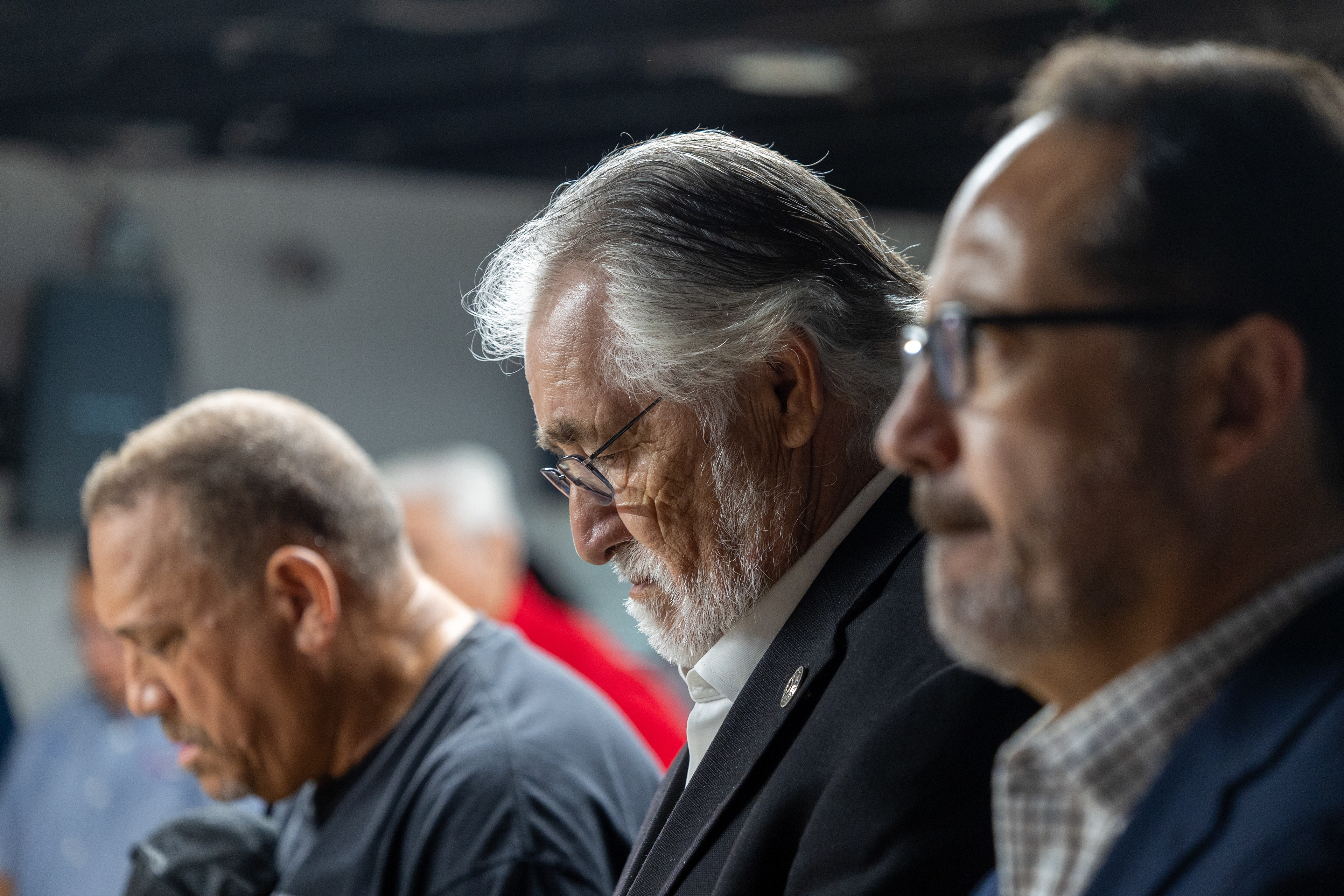 State Rep. Ray Lopez, D-San Antonio, bows his head in prayer next to state Sen. José Menéndez, D-San Antonio, during the third annual Memorial Flag Ceremony honoring Texas Veteran Suicide Prevention Day on Sept. 22, 2025, at VFW Post 76 in San Antonio.