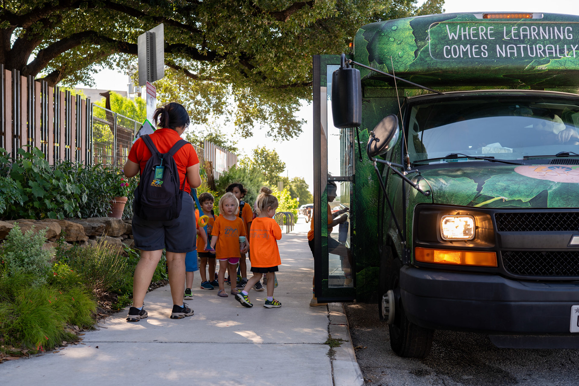 Children at the Will Smith Zoo School board a shuttle bus to the San Antonio Zoo for their daily lessons on June 17, 2025.