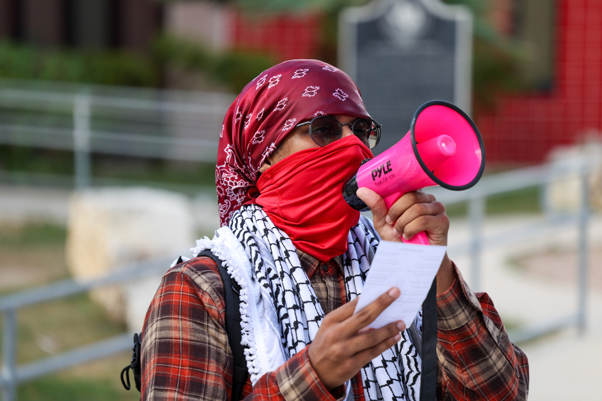 A member of the Fox Tech Student League, who requested to remain anonymous, leads chants outside Fox Tech High School during a planned walkout protest on Oct. 7, 2025, in San Antonio.