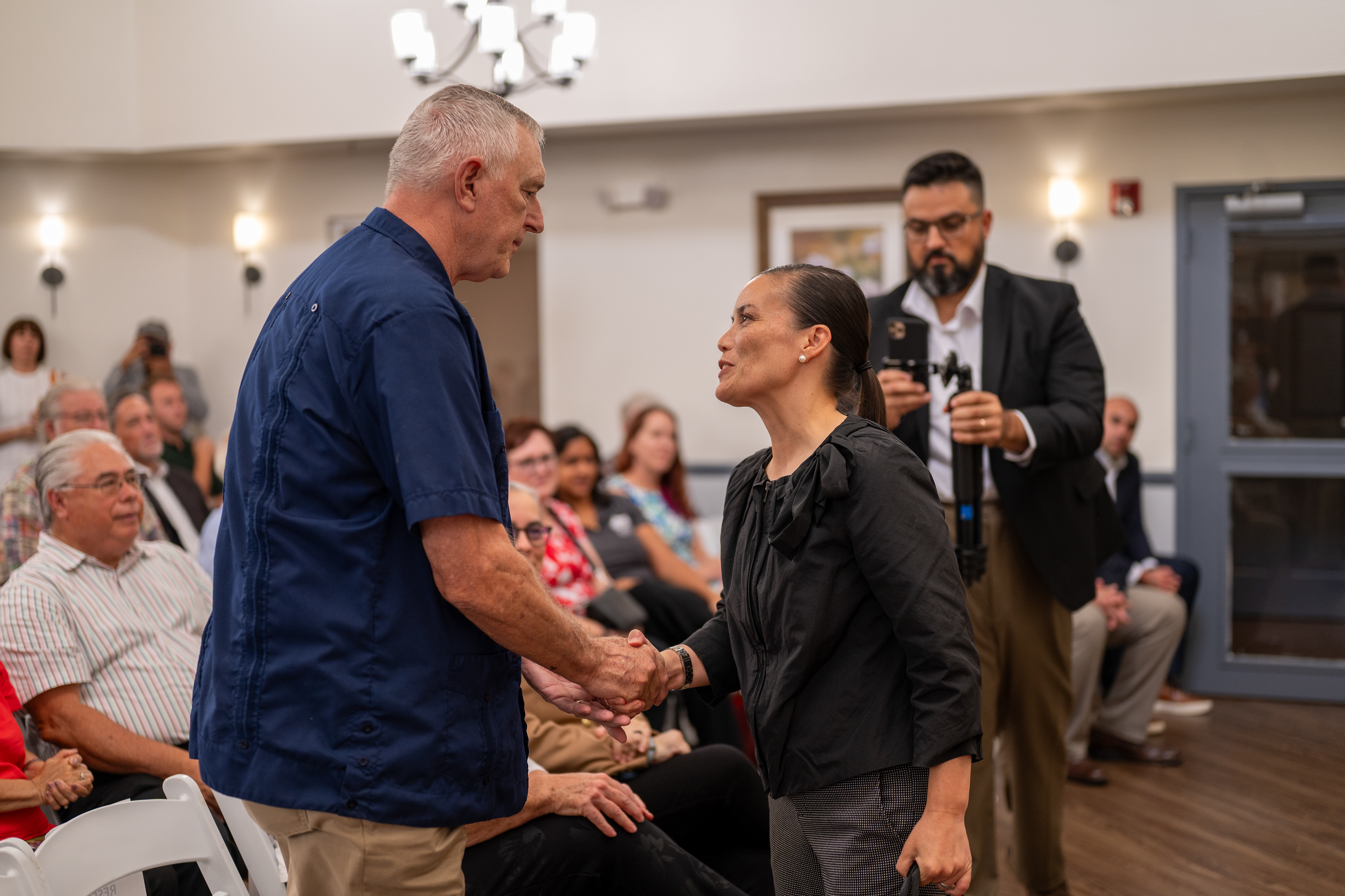 Michael Simpson shakes hands with San Antonio Mayor Gina Ortiz Jones during the ribbon-cutting for Valor Hill Apartments on July 29, 2025.