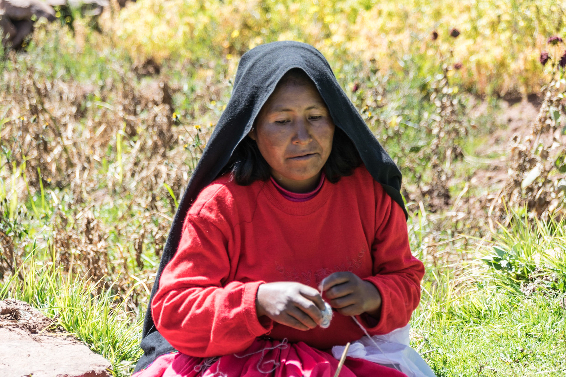 Lady spinning wool, Taquile Island, Lake Titicaca