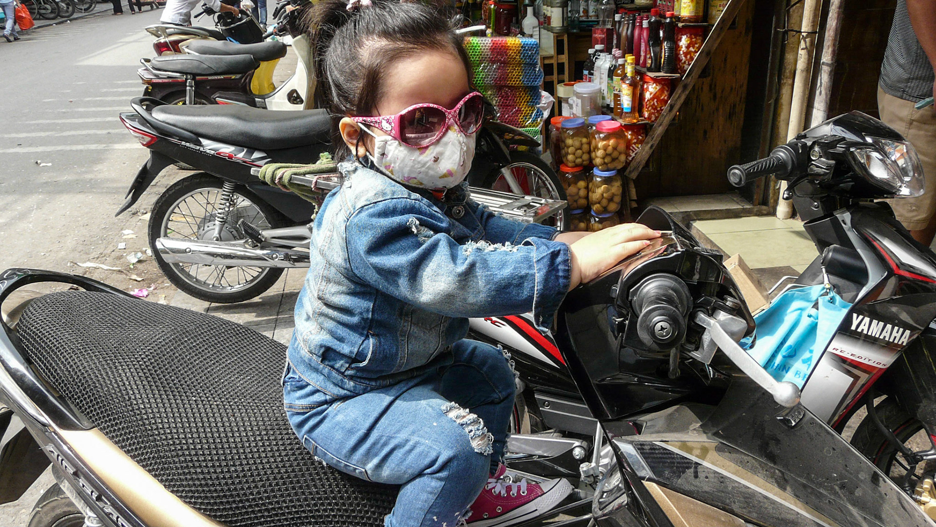 Small girl on motorbike, Hanoi, Vietnam, 2013