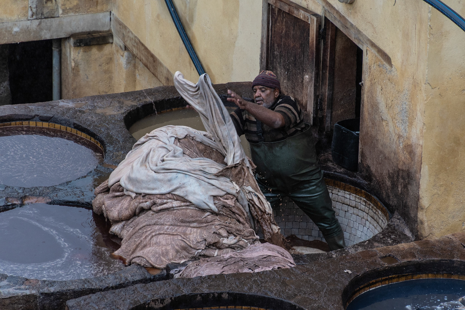 Man dyeing leather, Fes, Morocco, 2021