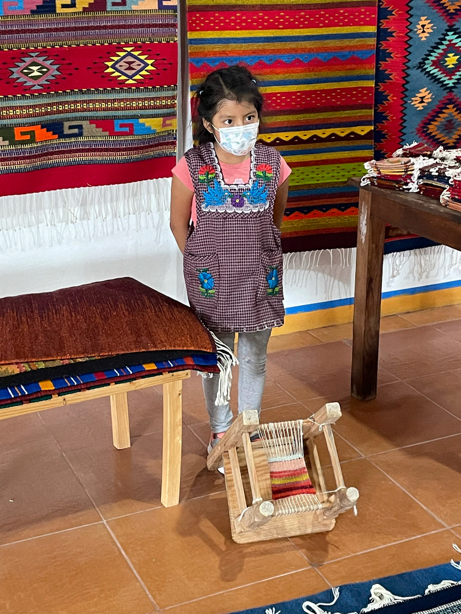 Young girl demonstrating weaving, Teotitlan del Valle, Mexico