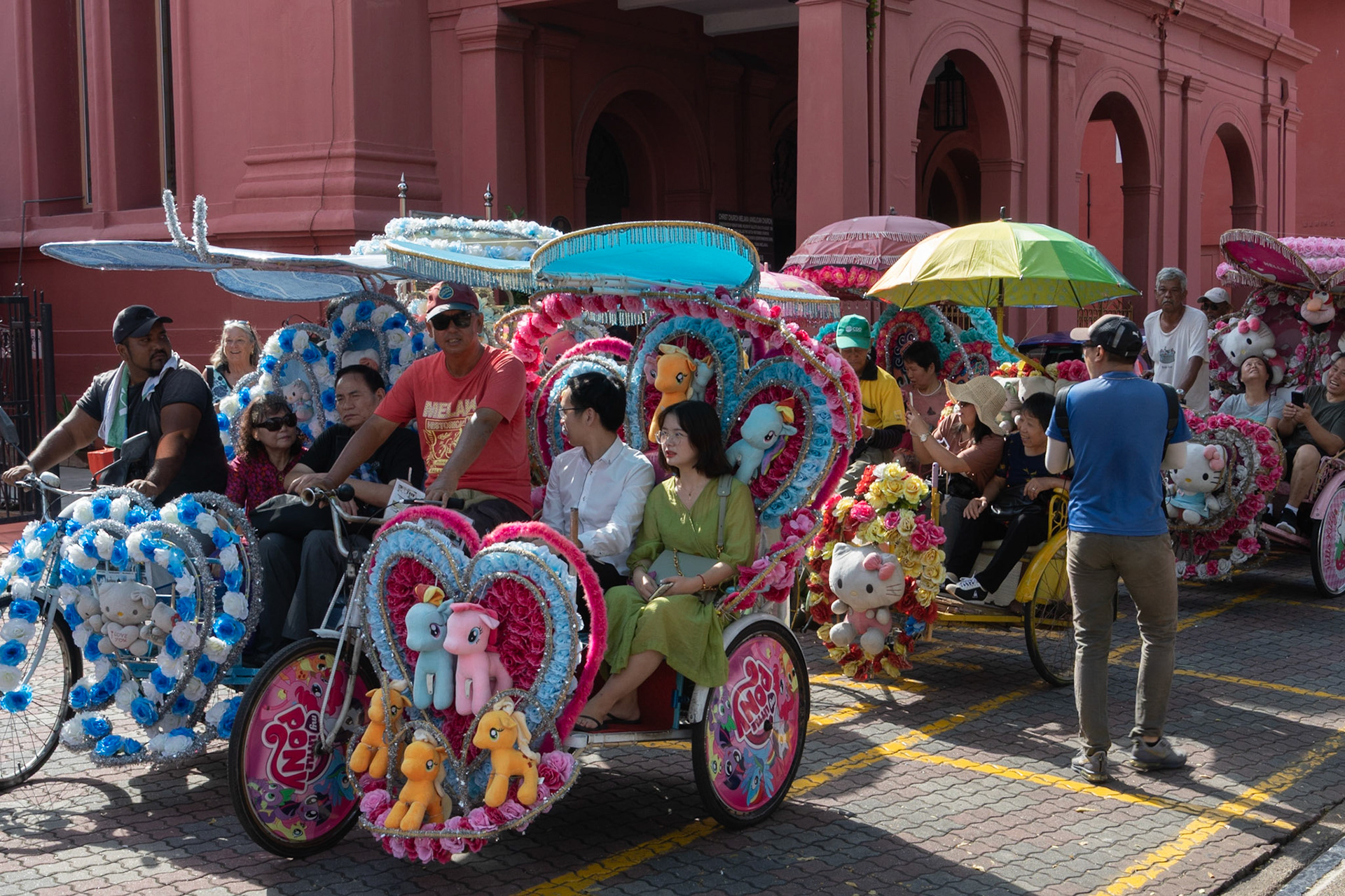 Tourists in garish rickshaws, Malacca, Malaysia, 2019