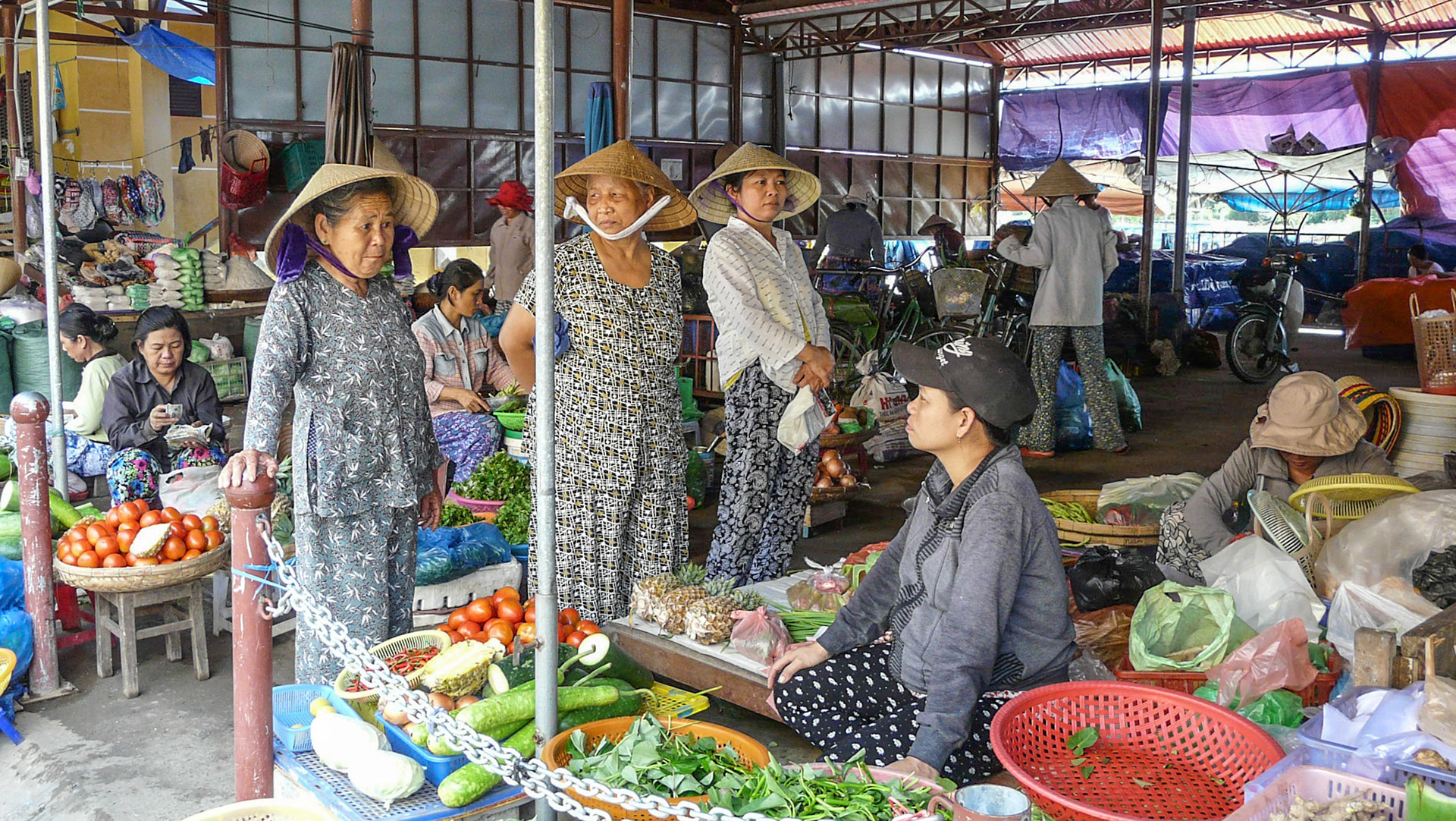 customers at market stalls, Hoi An, Vietnam