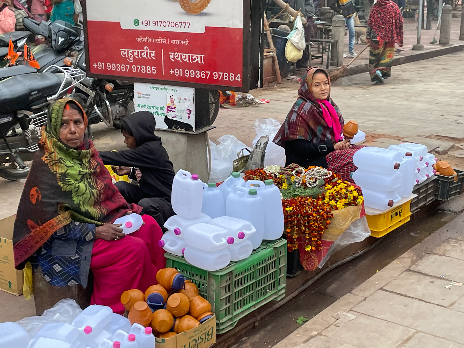Water container and flower sellers, Varanasi