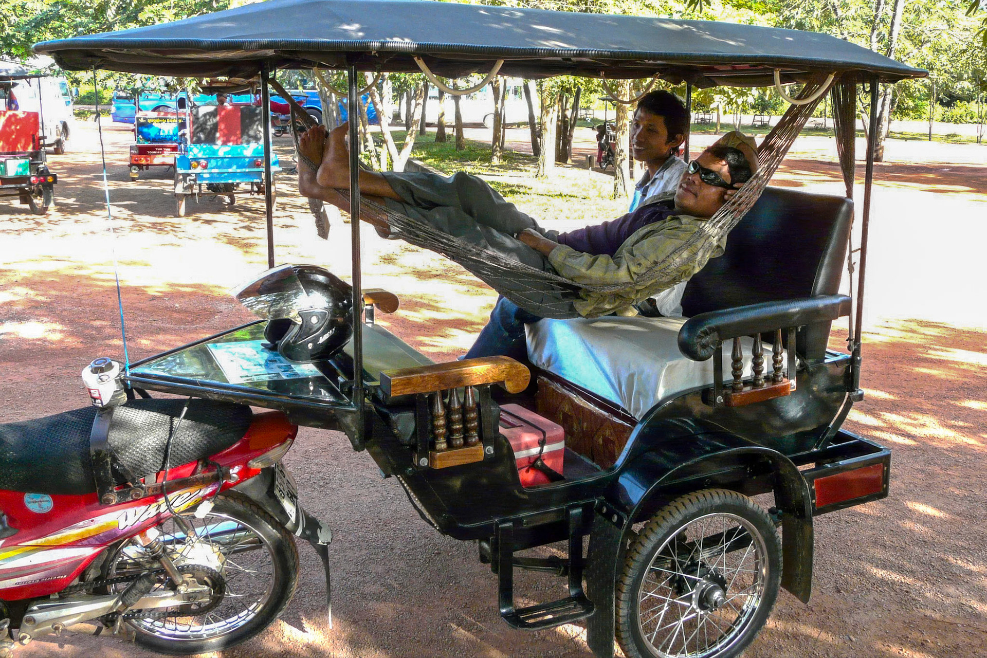 Taxi driver relaxing in hammock, Banteay Srei, Cambodia (InsideAsia East magazine)