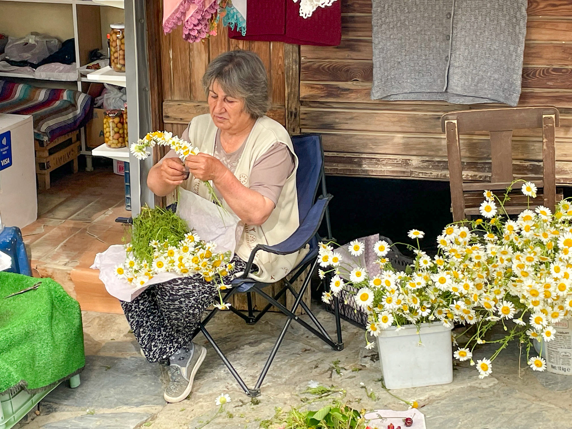Lady making flower garlands, Sirinice, Turkiye