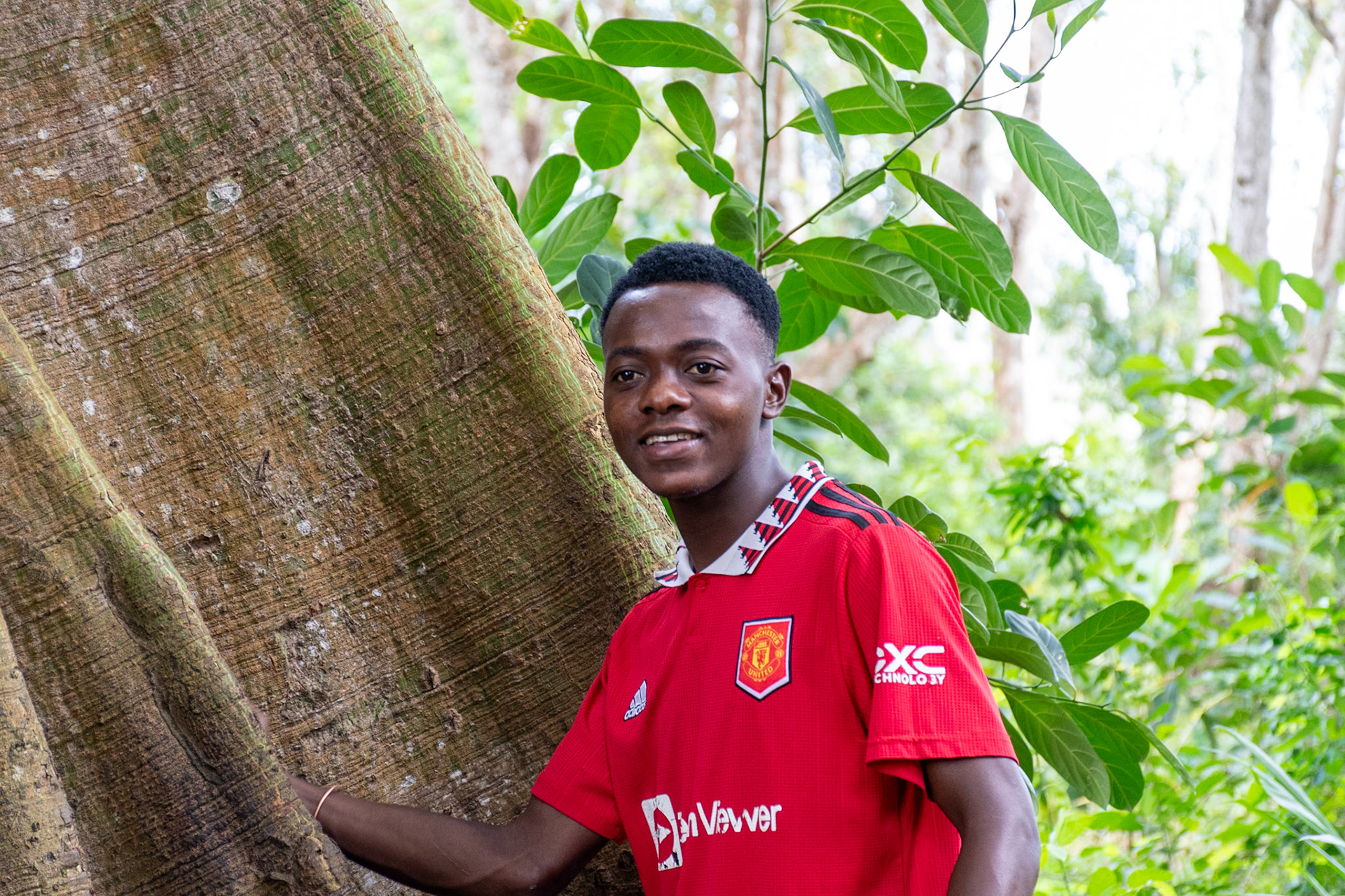 Guide beside Kapok tree, Kizimbani, Zanzibar