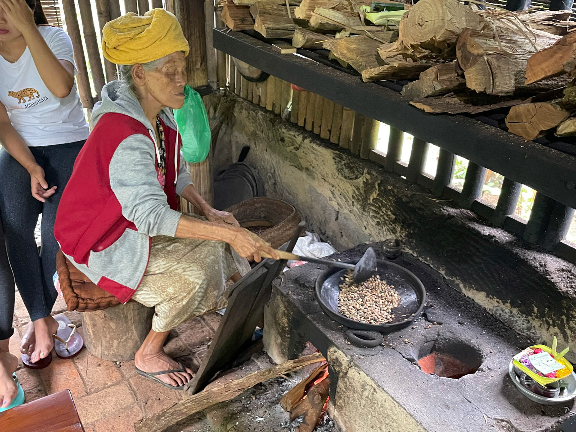Elderly lady roasting coffee, Ubud, Indonesia