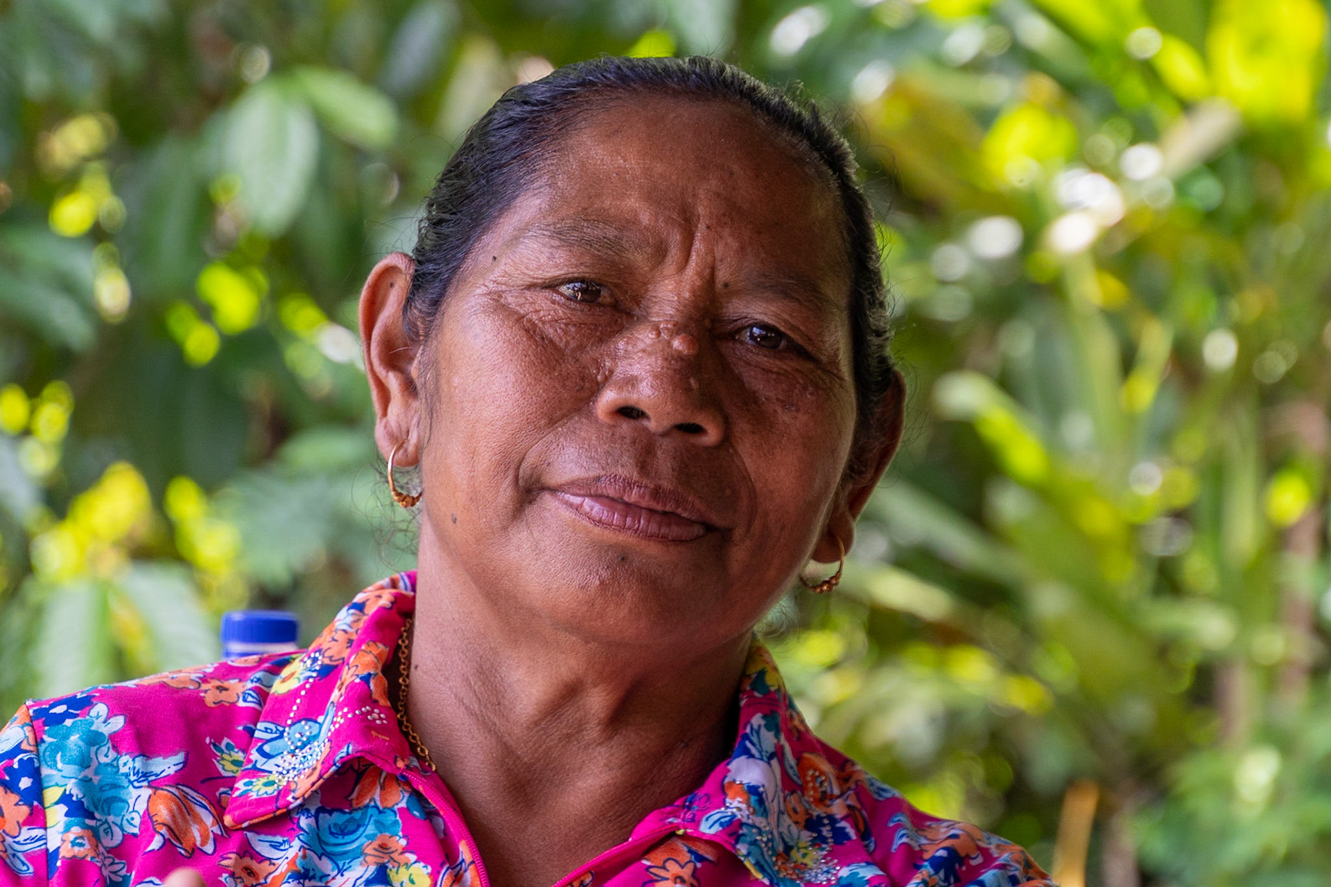 Lady with durian and coffee shop, Cancar, Indonesia