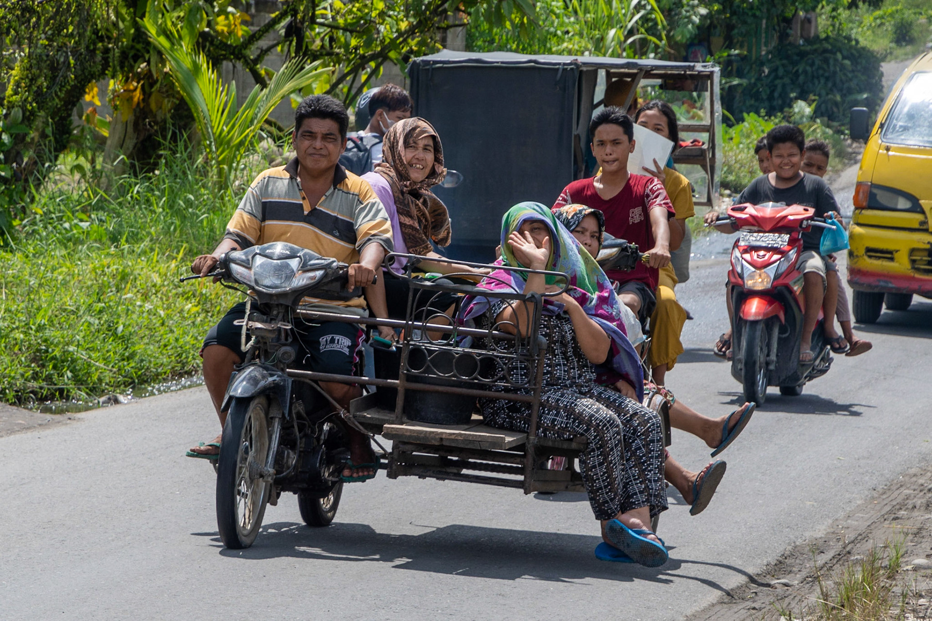 People riding on a becak, en route to Berastagi, Sumatra, Indonesia, 2022