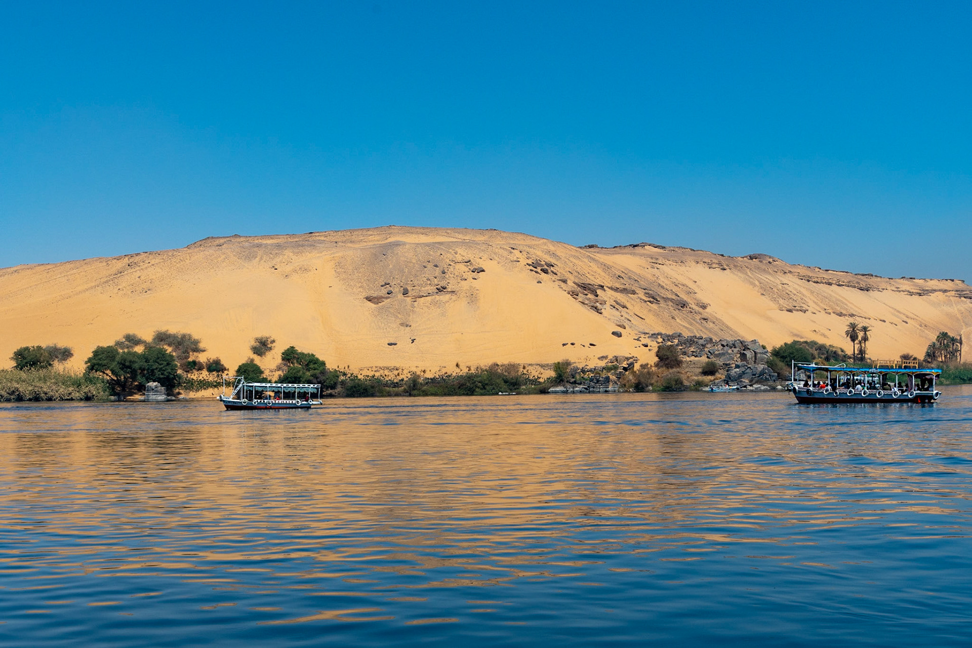 Sand dunes at edge of River Nile, Aswan, Egypt
