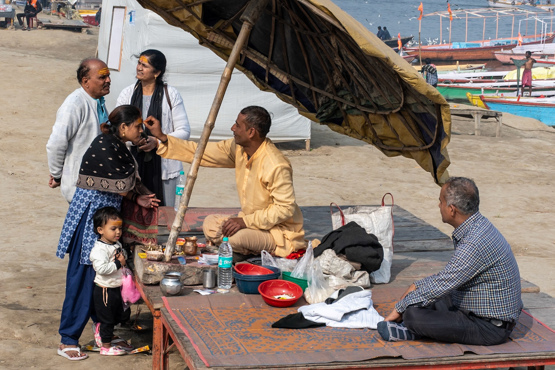 Lady receiving bindi, Varanasi, India, 2024