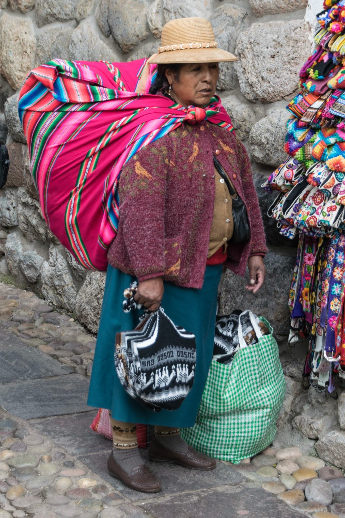 Lady with heavy load, Cusco, Peru