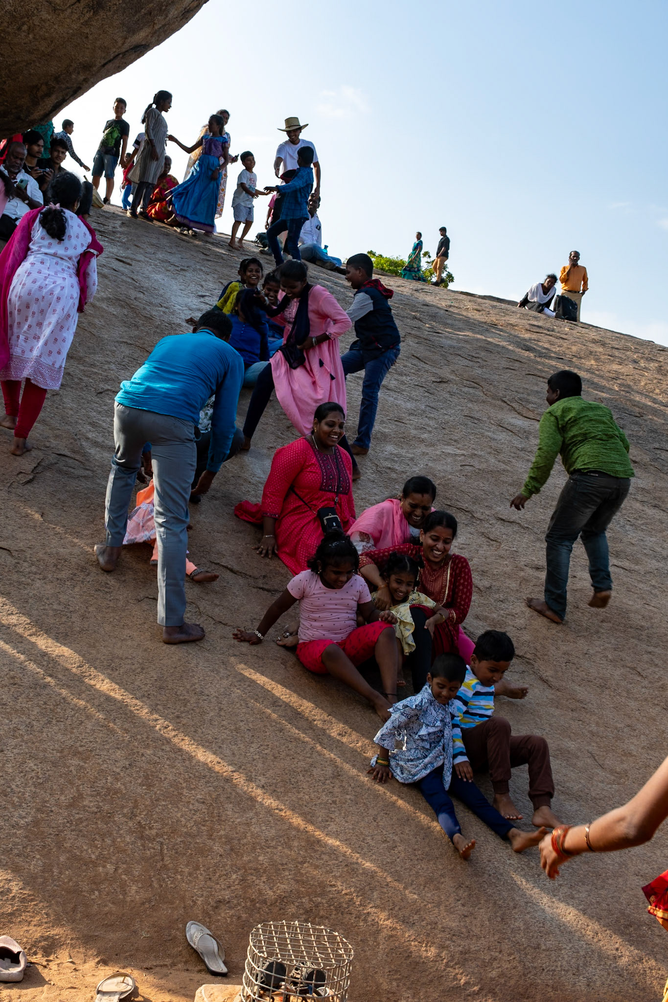 Sliding down rocks, Krishna's Butterball, Mahabalipuram
