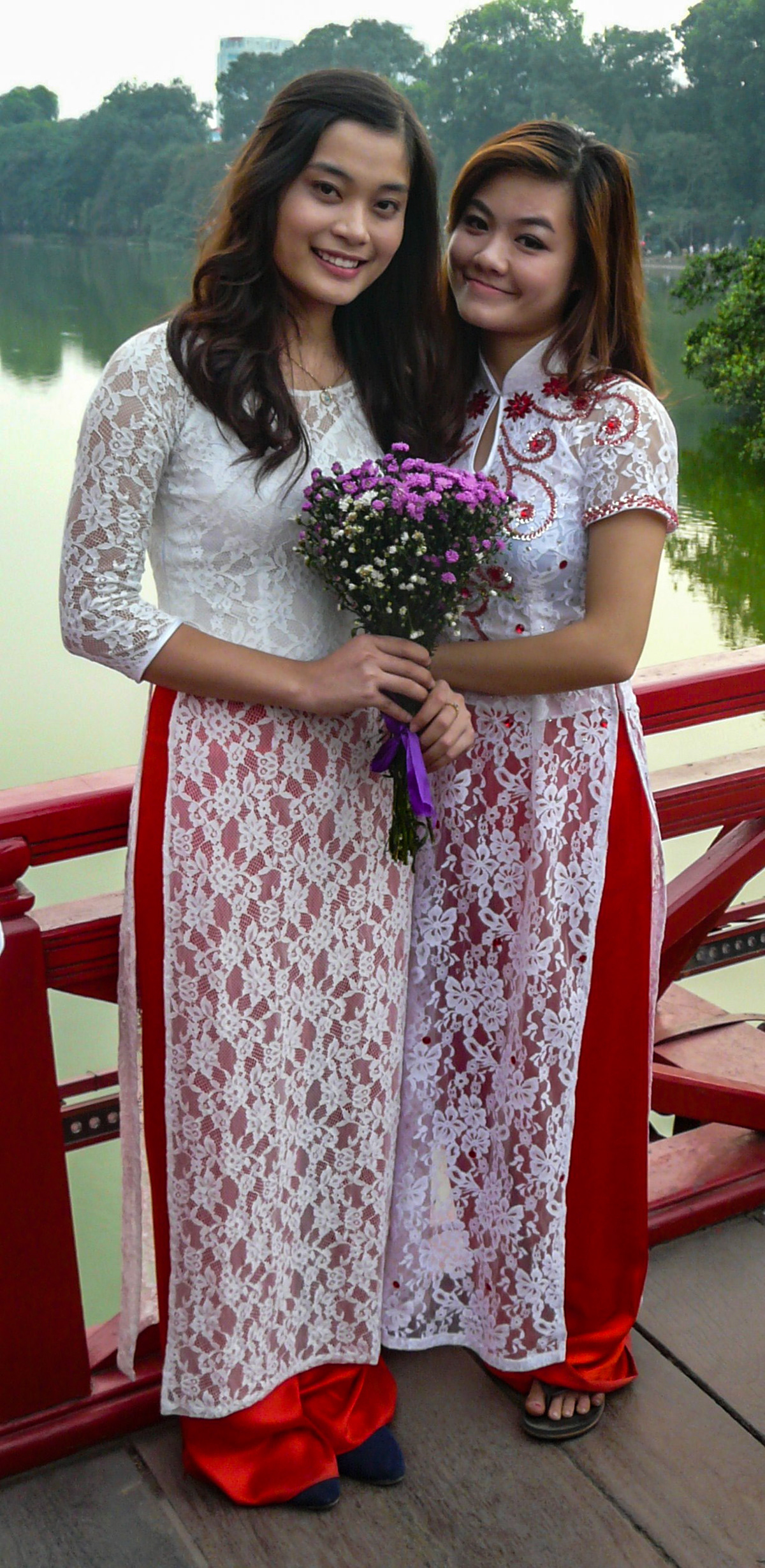 Two girls on Huc Bridge, Hanoi, Vietnam