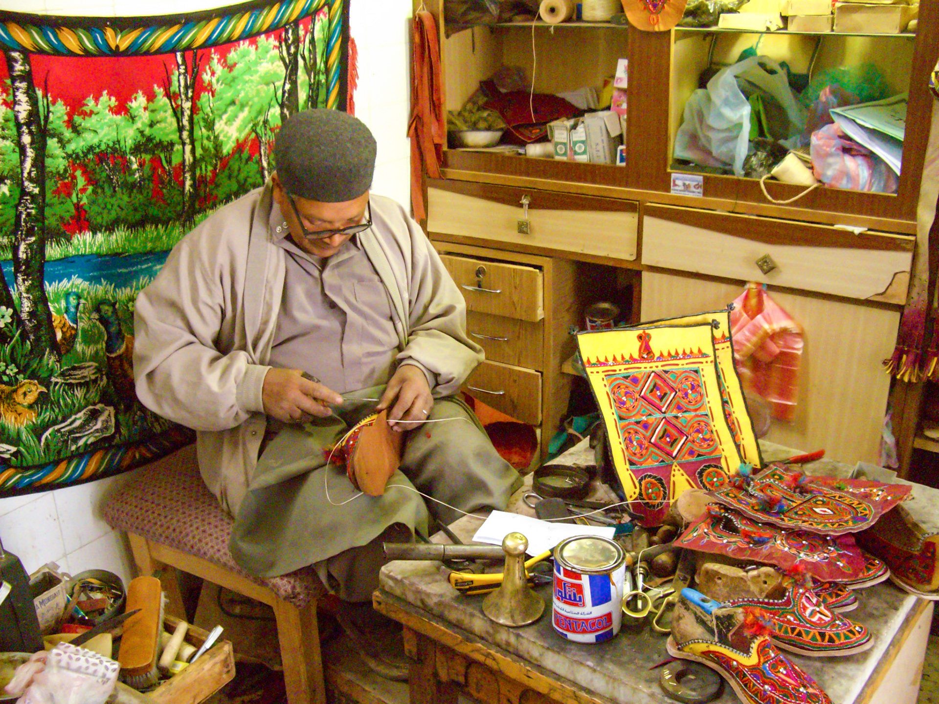 Cobbler making traditional embroidered shoes, Ghadames, Libya, 2007
