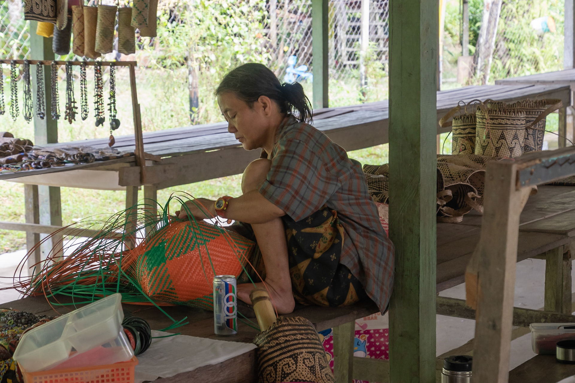 Lady weaving a basket, Batu Bungan, Mulu, Malaysia