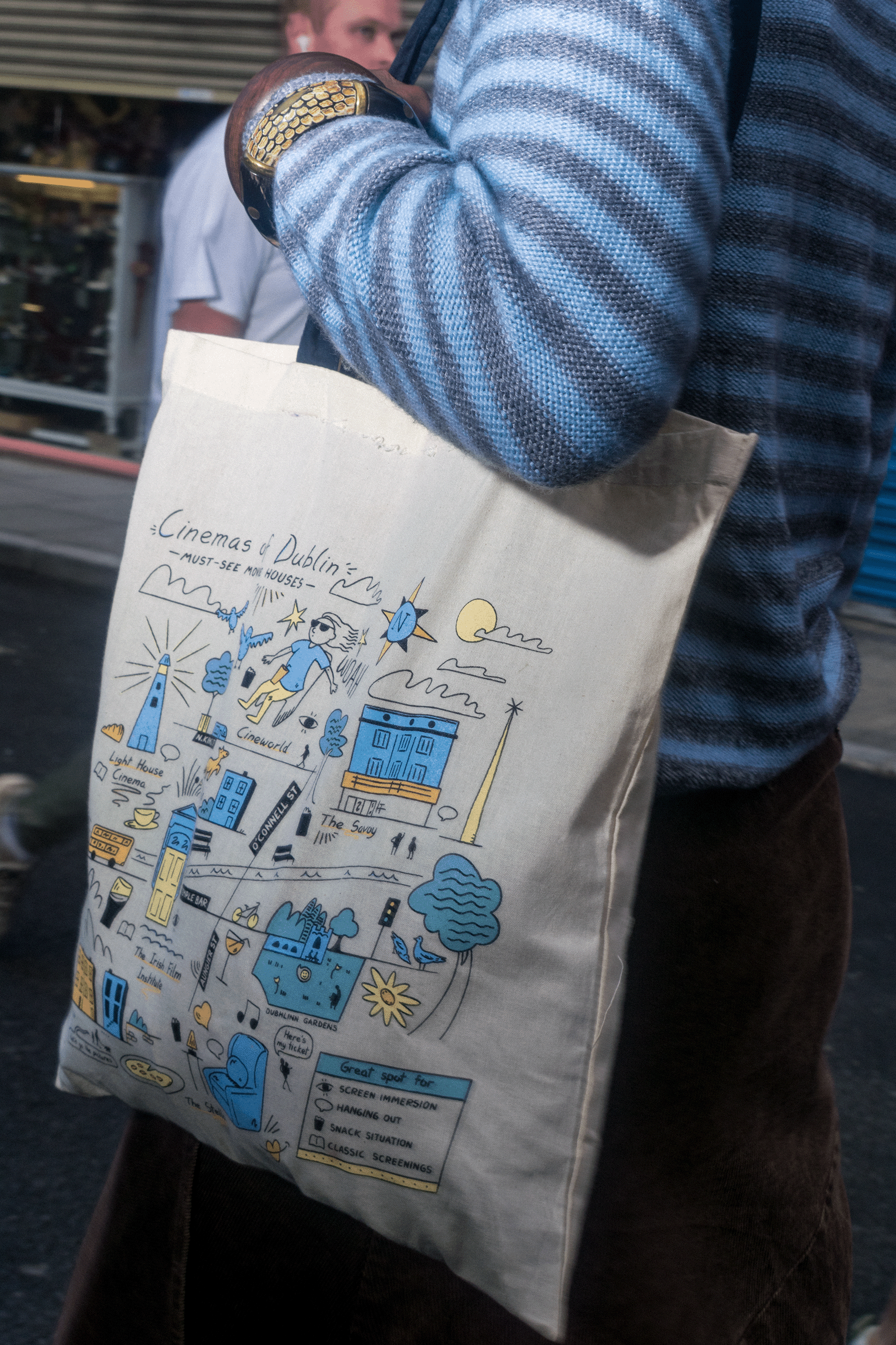 Photo of a model sporting the Cinemas of Dublin tote bag by Amy Lauren and Film In Dublin. Photo 2 of a close up of the bag.