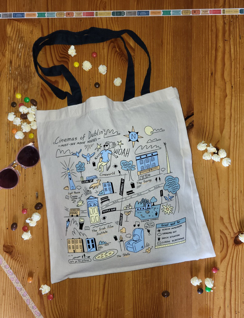 A photo of a tote bag featuring the most iconic cinemas of Dublin: the Savoy, Cineworld, the Irish Film Institute or IFI, the Stella and the Light House. It also features a legend showing the key selling points of each cinema: screen immersion, good hanging out spots, the snack situation and cinemas showing classic screenings.