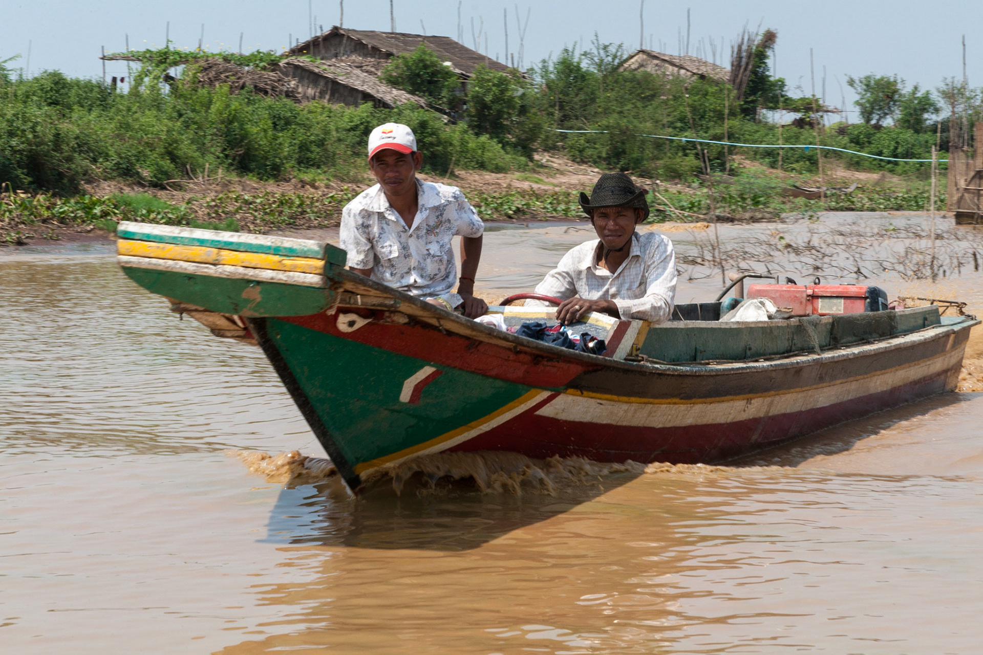 Two local fishermen approaching by boat on a klong (canal) close to Tonle Sap Lake