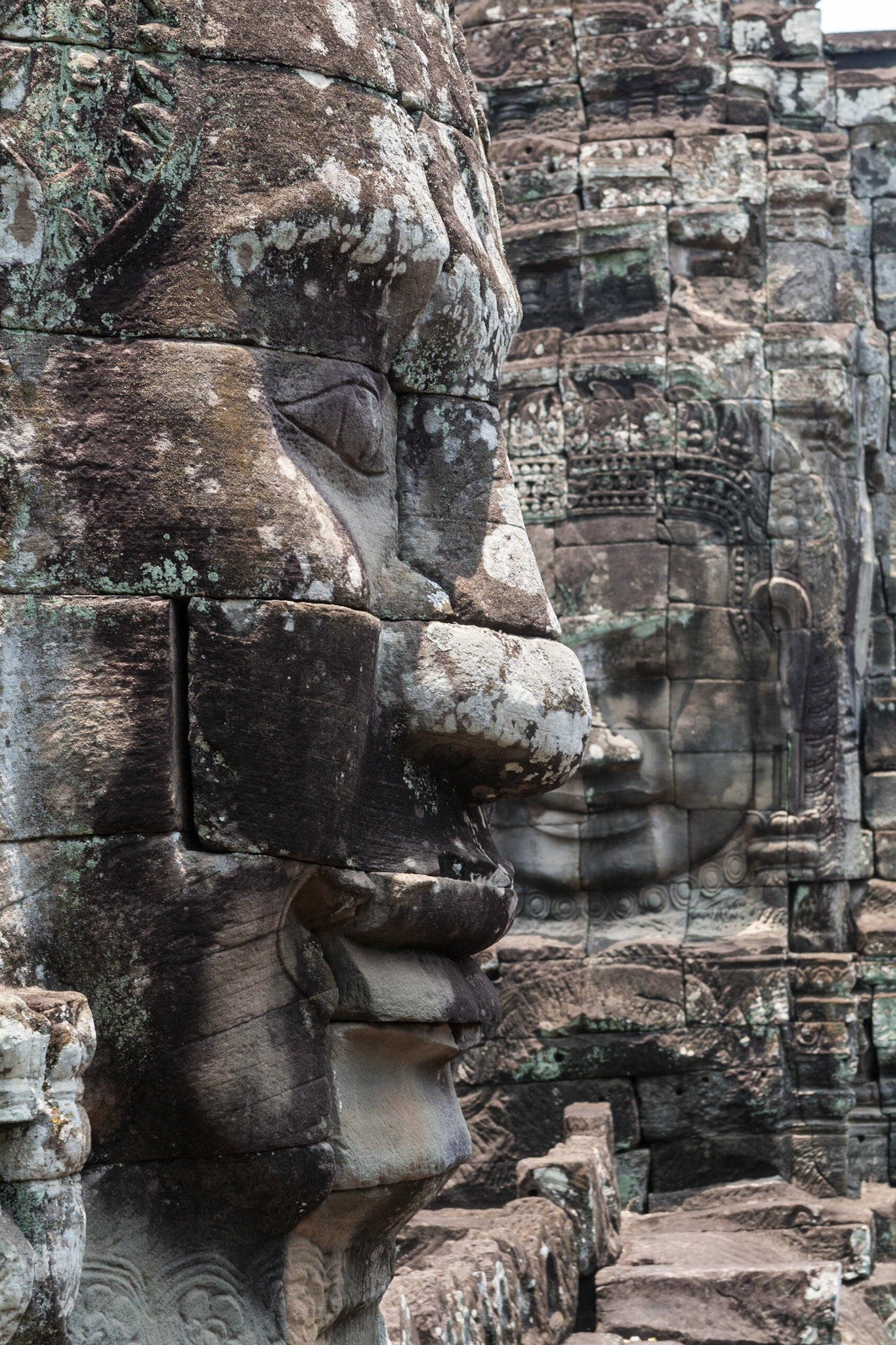 Two of the once 216 faces (Bodhisattva Avalokiteshvara) in the ruins of the Bayon temple in Angkor Thom