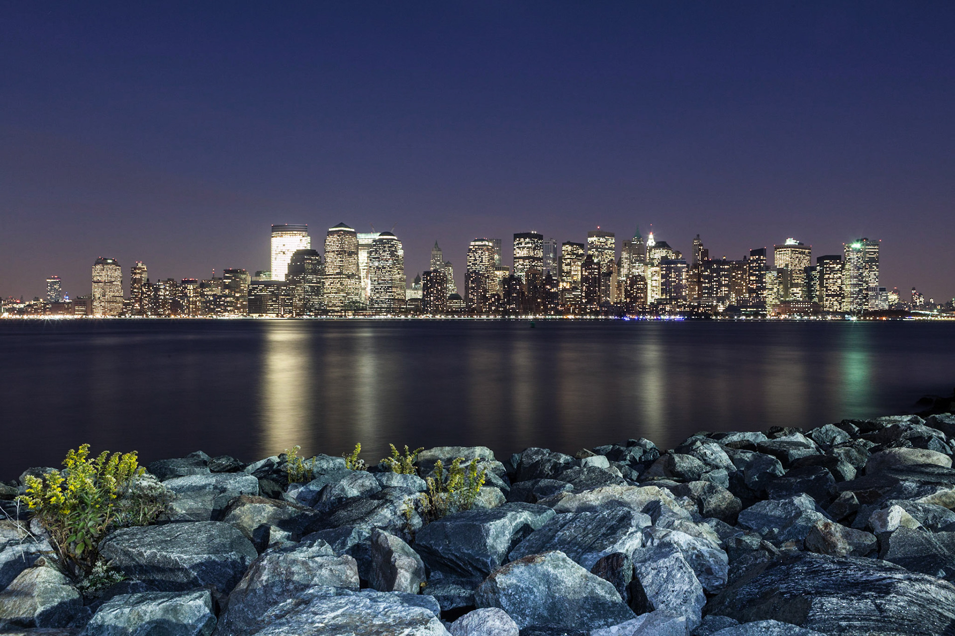 A view of the Downtown Manhattan skyline from the Liberty State Park in New Jersey. The rocks in the foreground have been slightly lightpainted.