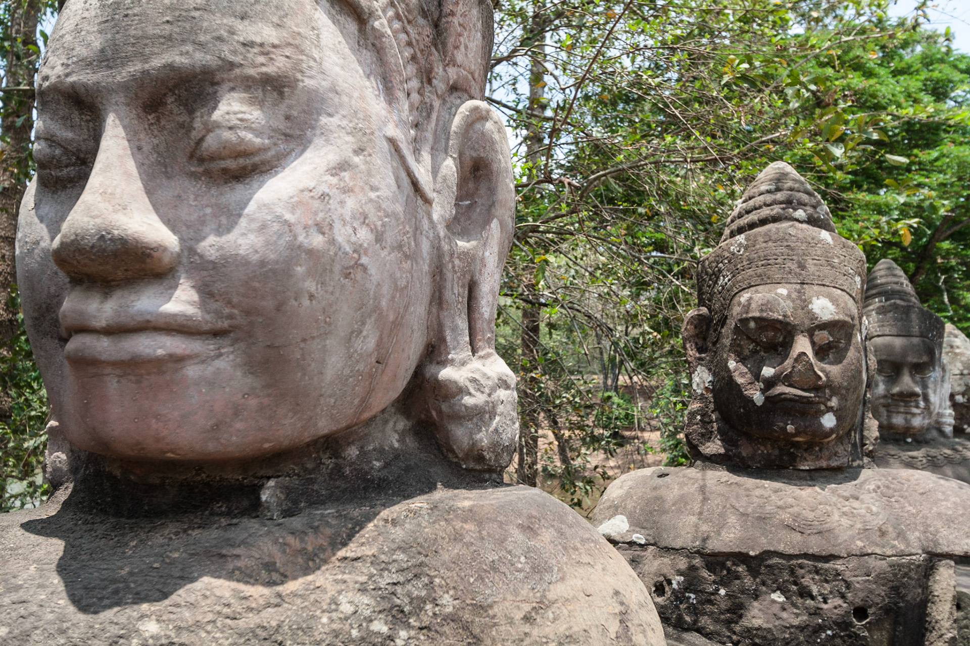 A group of asuras (power-seeking deities) holding a naga (sacred snake) leading to the South Gate of Angkor Thom
