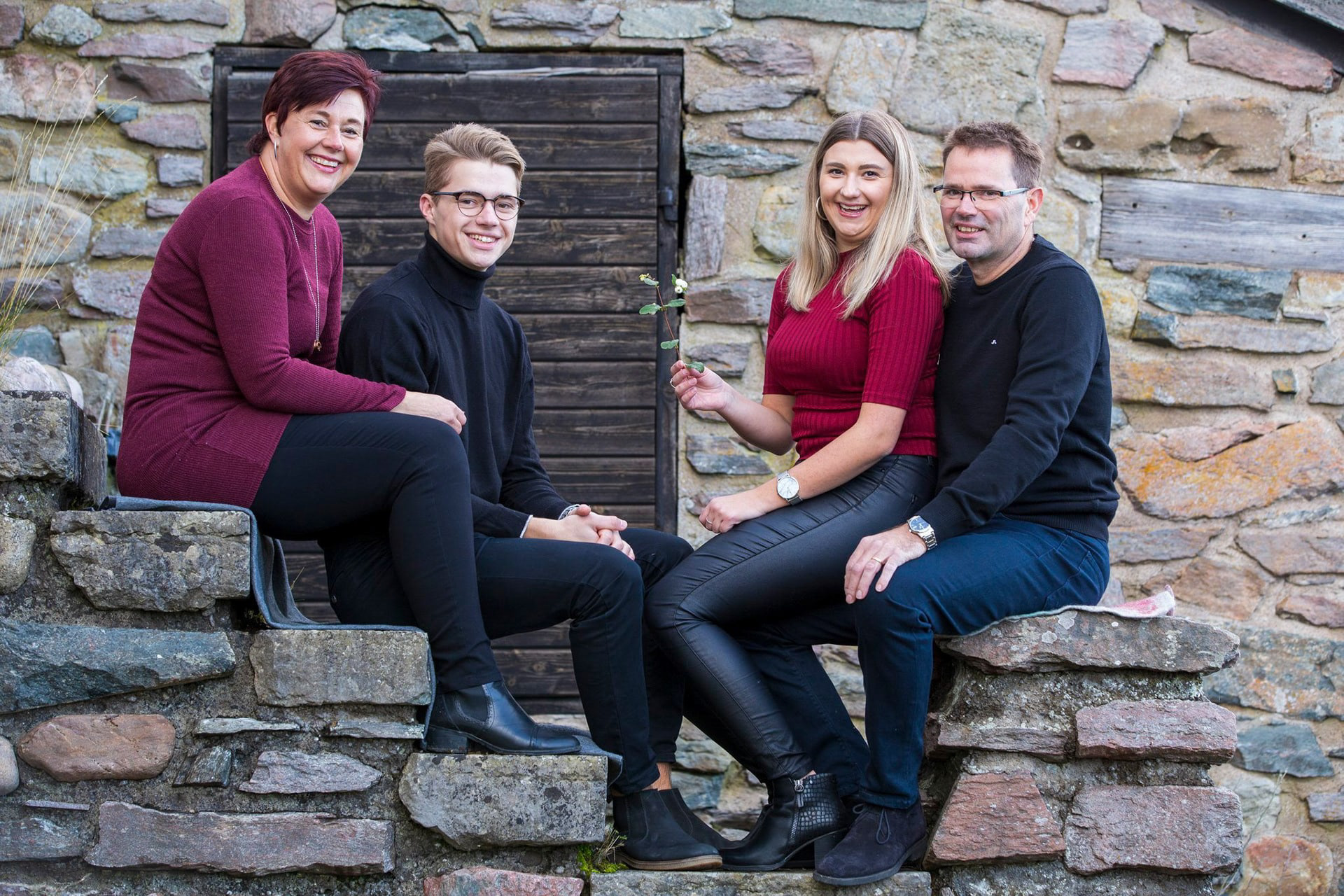 En familj sitter på en stentrappa