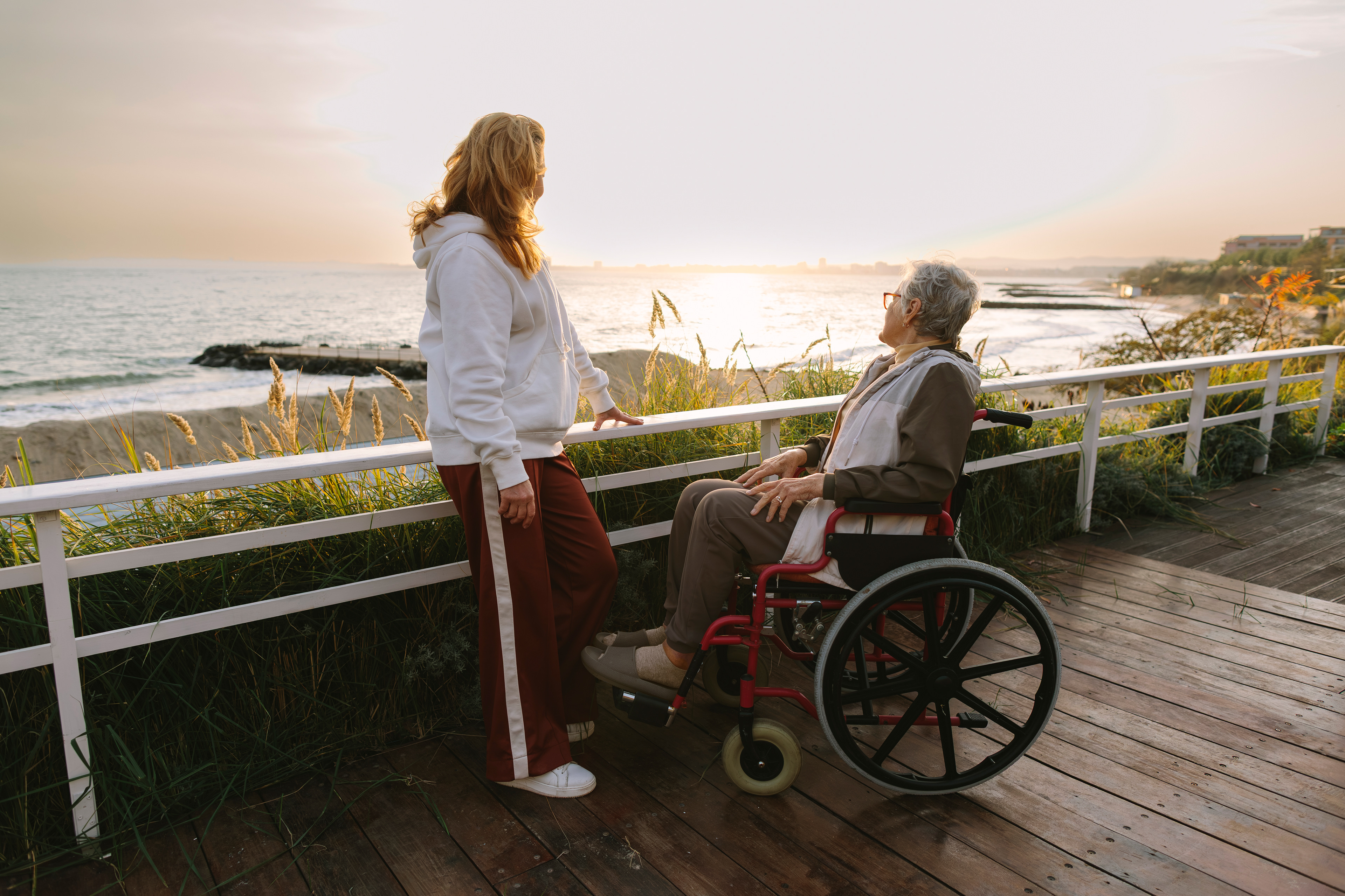 Shared moments by the sea — care, respect, emotional support, intergenerational bond, presence, empathy, human connection, everyday dignity. By Svetlana Iakusheva
