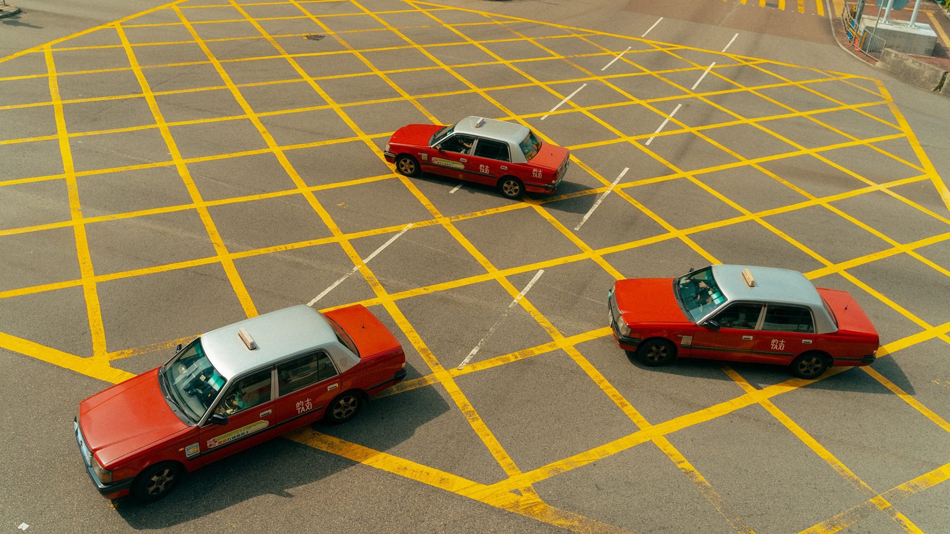 rote taxis auf gelber kreuzungsmarkierung, hongkong, 2025