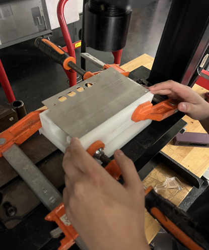Using a hydraulic press to shape the triangular handles