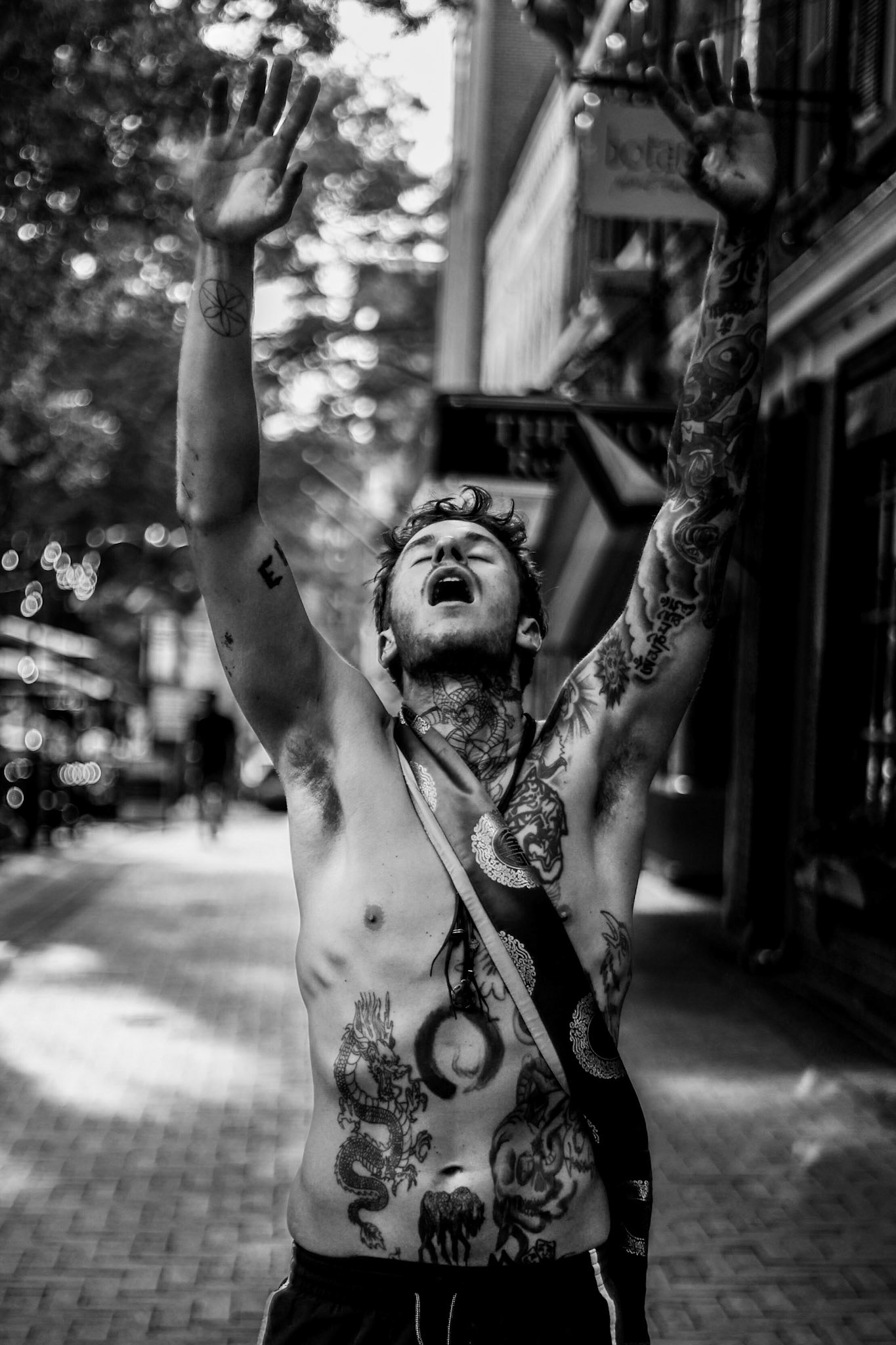 An unknown man gestures toward the camera on Charlottesville's Downtown Mall.