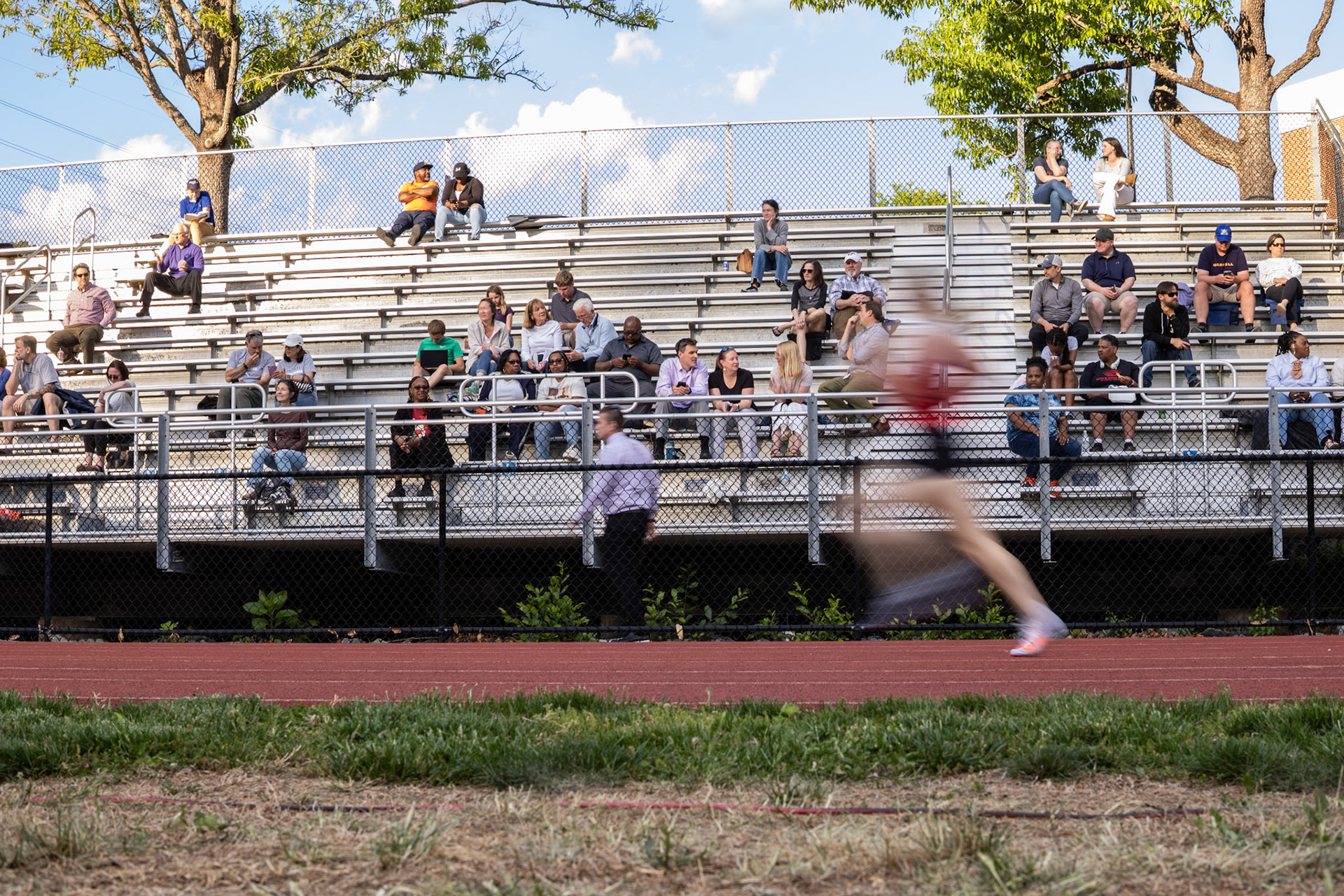 A runner passes by at a track meet at Charlottesville High School. April 22, 2026