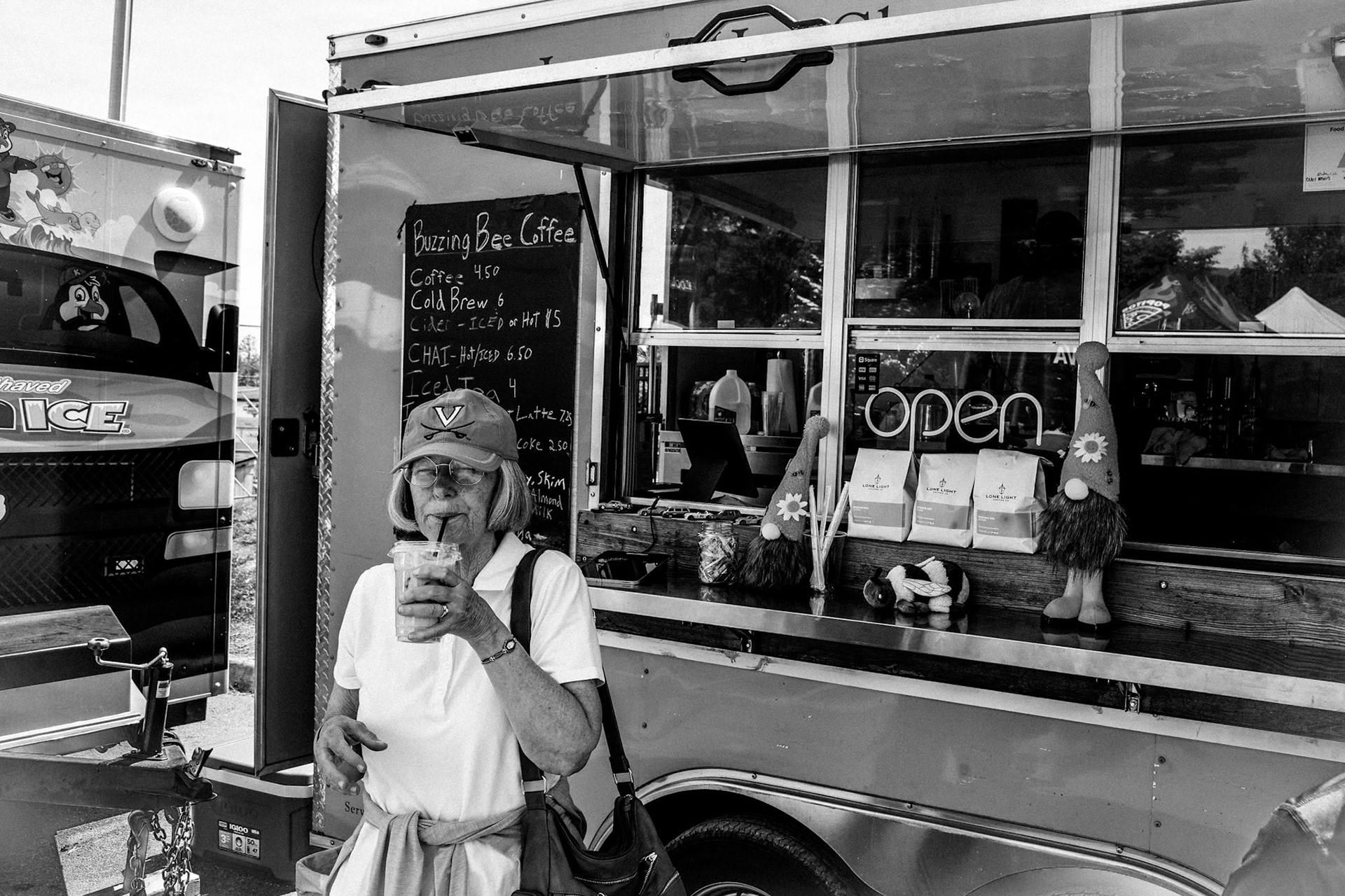Donna Turner sips a coffee purchased from Buzzing Bee Coffee at the Crozet Arts and Crafts Festival. May 10, 2025