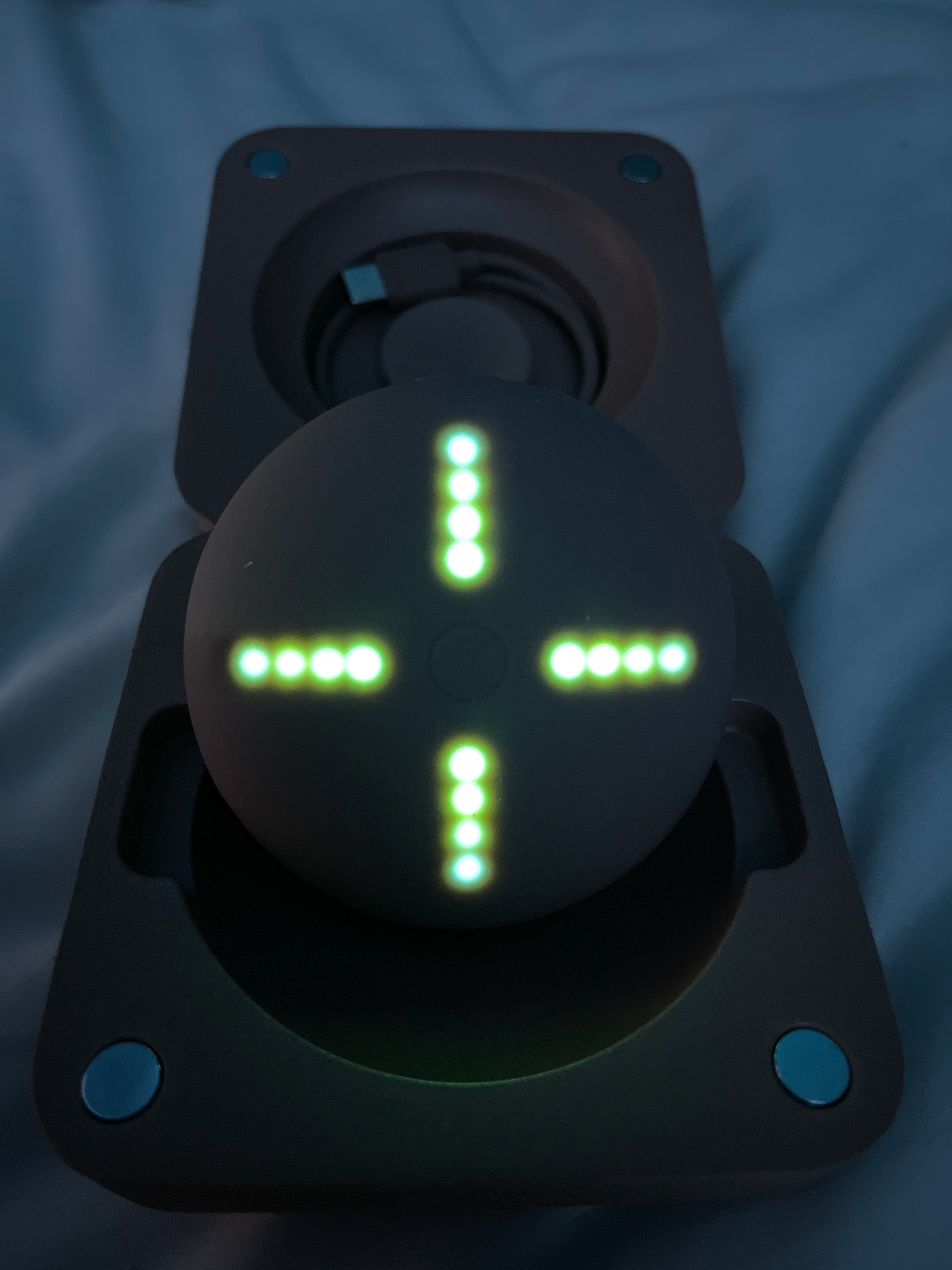 A photograph of the Yzy Tech x Kano Donda Stem Player with the lights lit up green