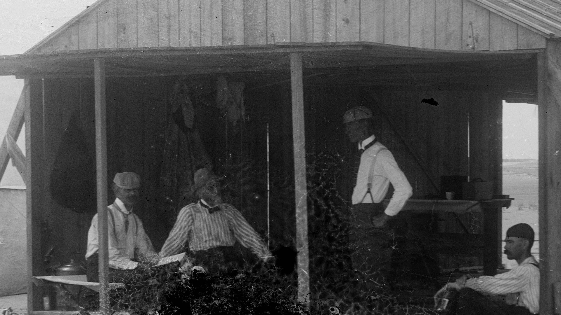 Wrights' work shed, Kitty Hawk, North Carolina. Left to right: Edward C. Huffaker, Octave Chanute, Wilbur Wright, and George Spratt, 1901.