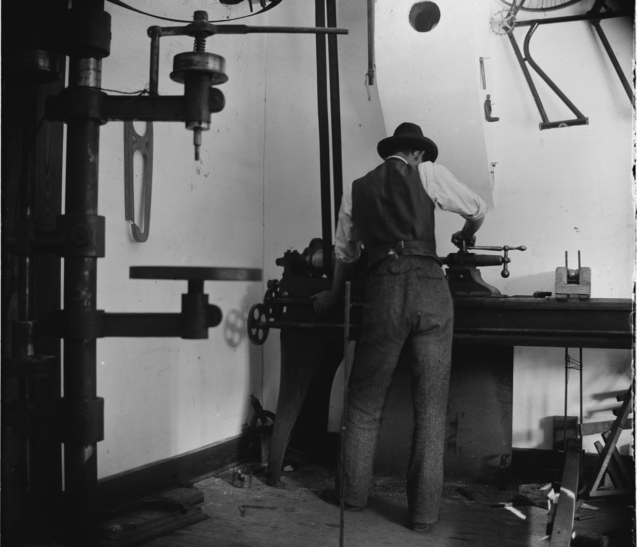 Wilbur Wright working in the bicycle shop, Dayton, Ohio, 1897.