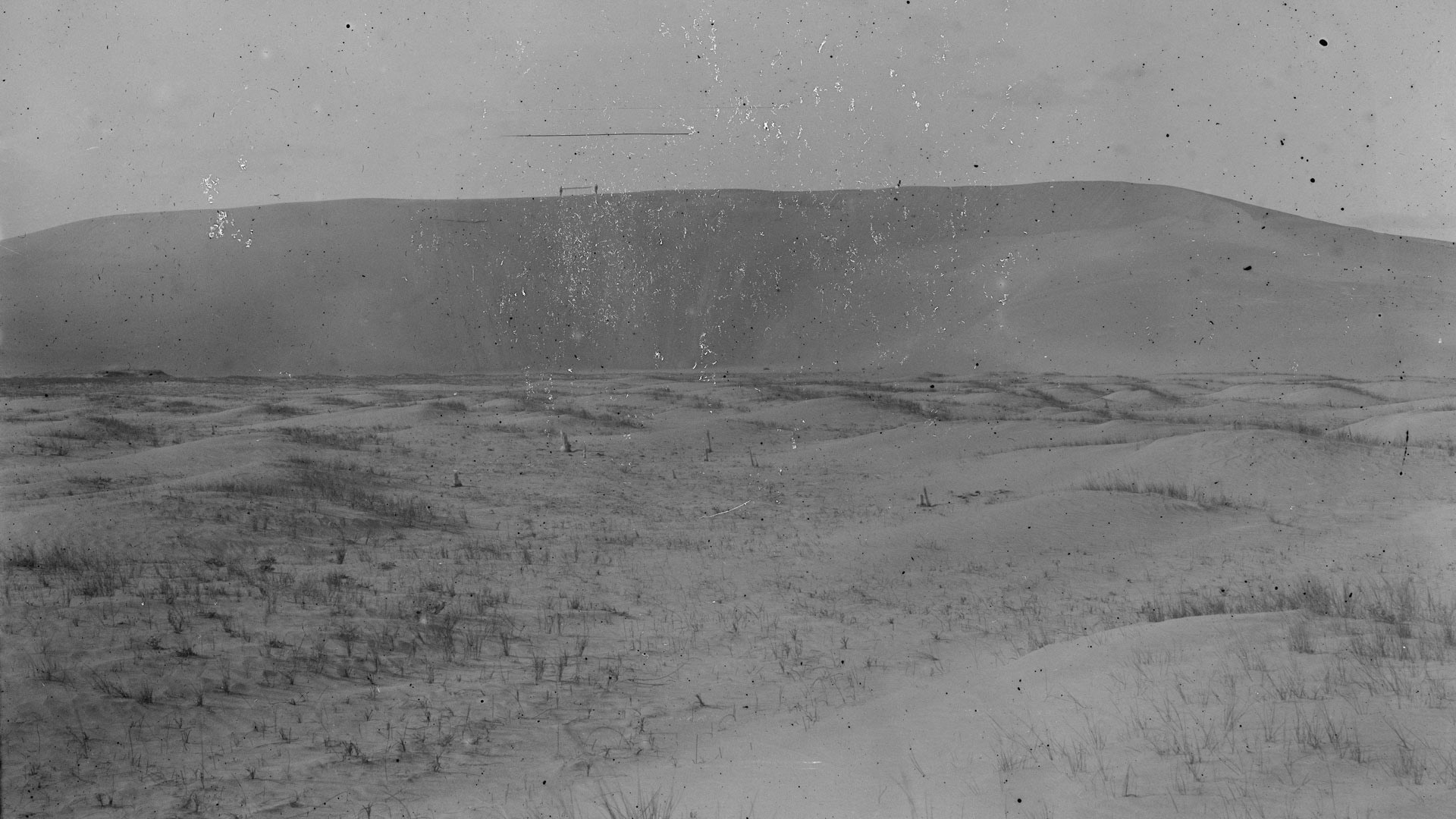 Kill Devil Hill with figures carrying Wright glider, North Carolina, 1901.