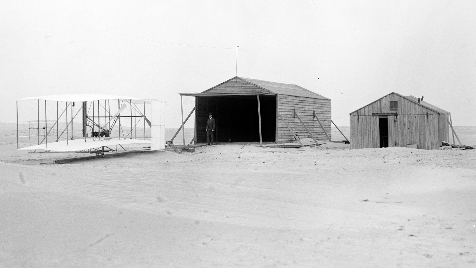 1903 Flyer and camp buildings, Wilbur Wright, November 24, Kitty Hawk, North Carolina.
