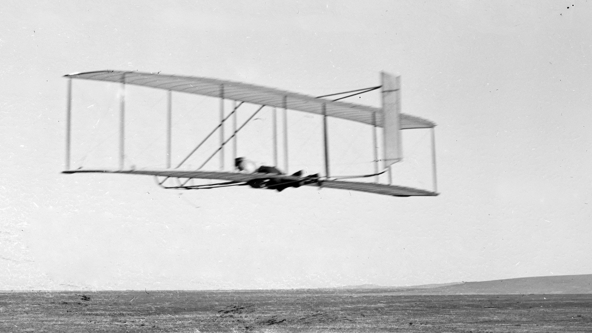 Wilbur Wright flying 1902 glider, Kitty Hawk, North Carolina.