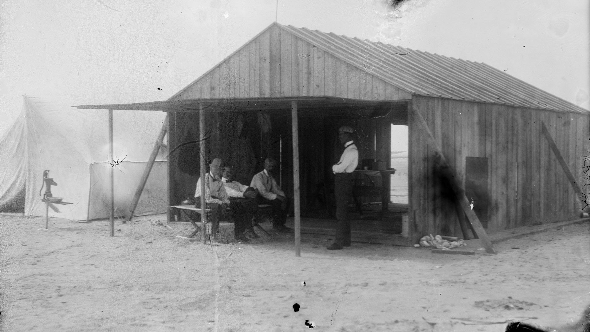 Wrights' work shed at Kitty Hawk, North Carolina. Left to right: Octave Chanute, Orville Wright, Edward C. Huffaker, and Wilbur Wright, 1901.