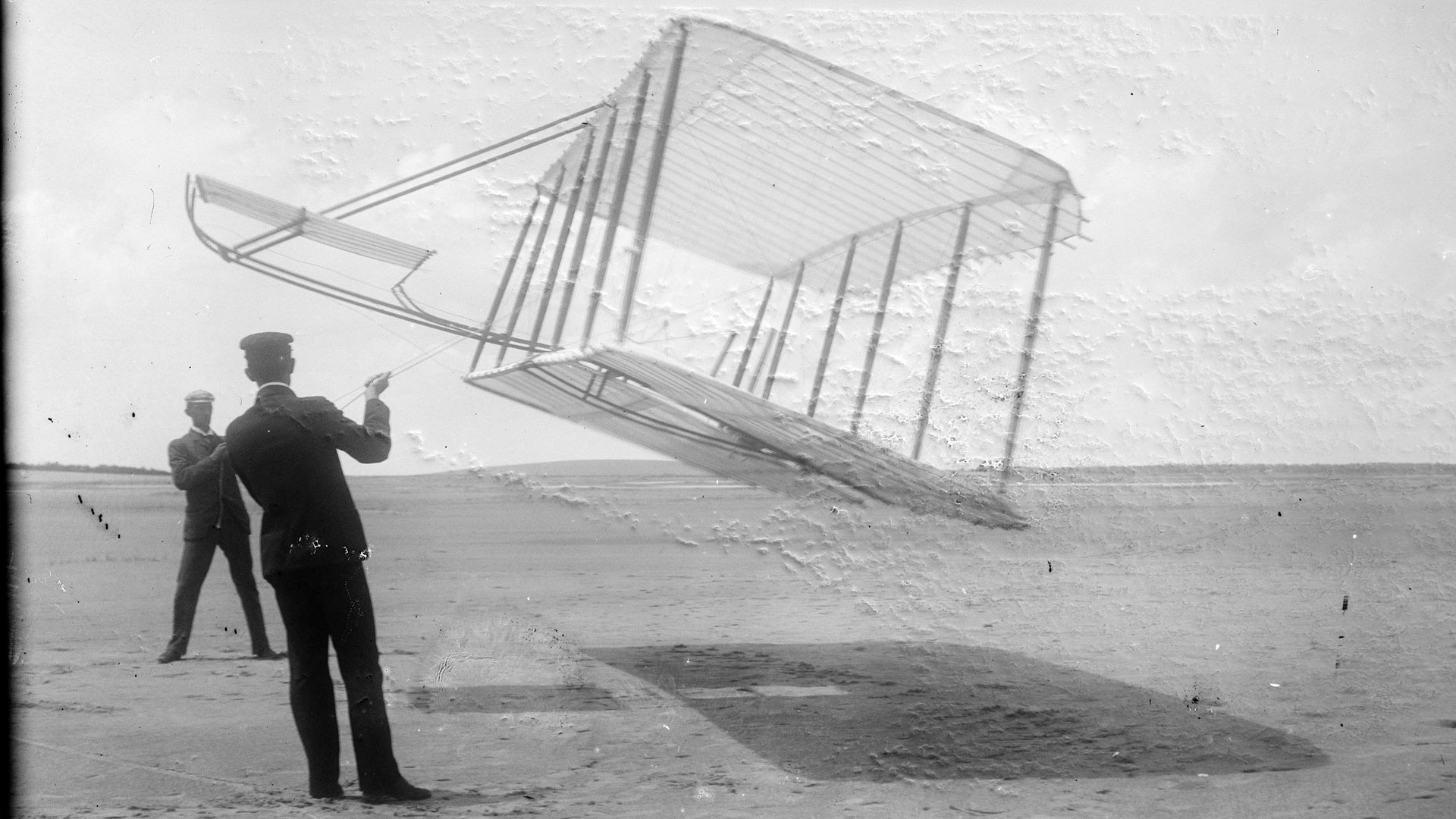 1901 Wright glider flown as kite, Wilbur at left and Orville at right, Kitty Hawk, North Carolina.
