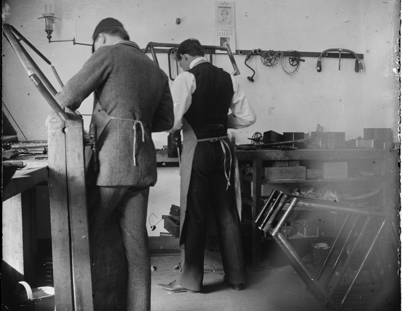 Orville Wright and Edwin H. Sines, neighbor and boyhood friend, filing frames in the back of the Wright bicycle shop, Dayton, Ohio, 1897.