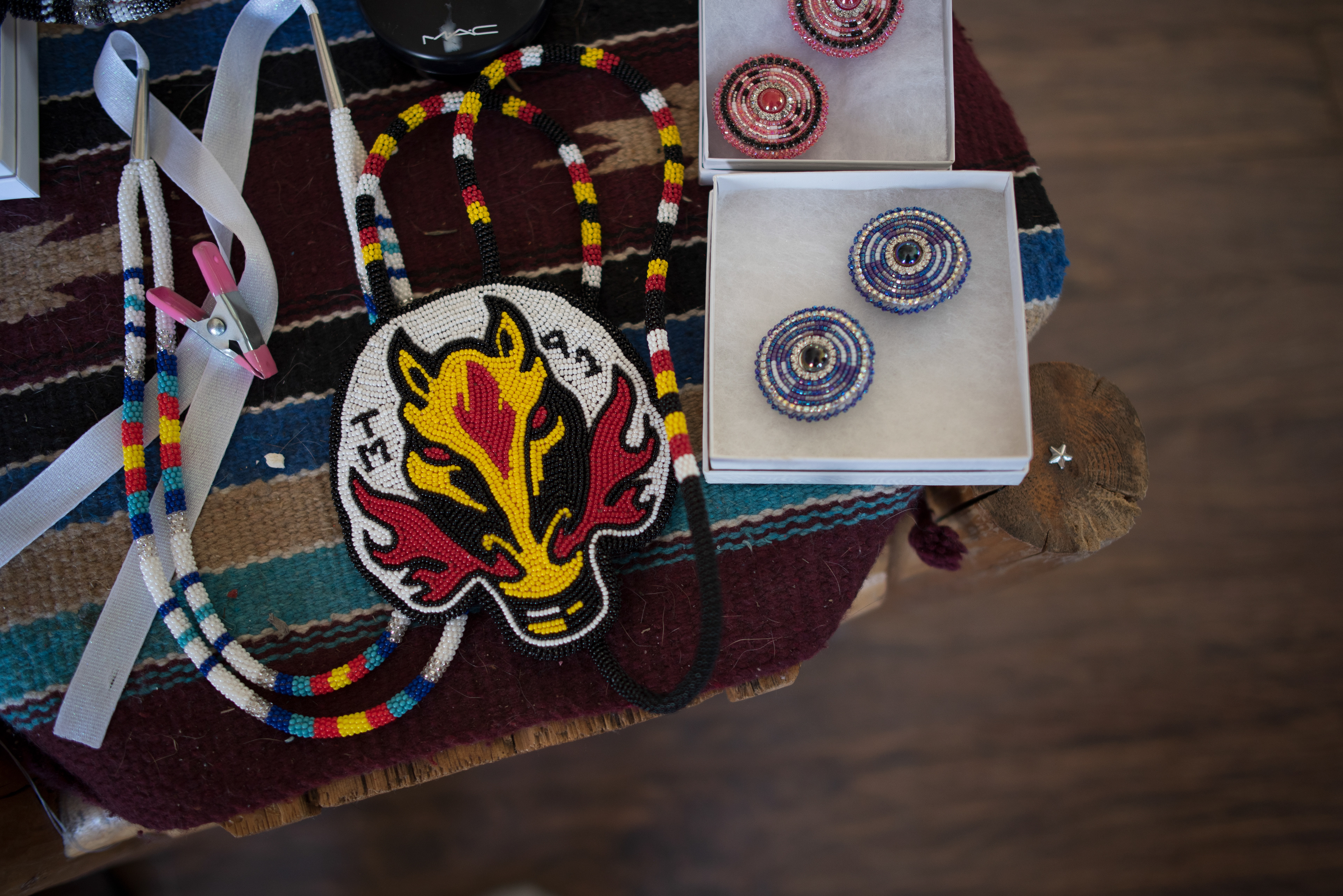 Some of the beadwork by Ashley Wright, including a Calgary Flames Blasty medallion, is displayed at Livia Manywounds’s home on the Tsuut’ina Nation in Treaty 7. SARAH B GROOT/THE GLOBE AND MAIL