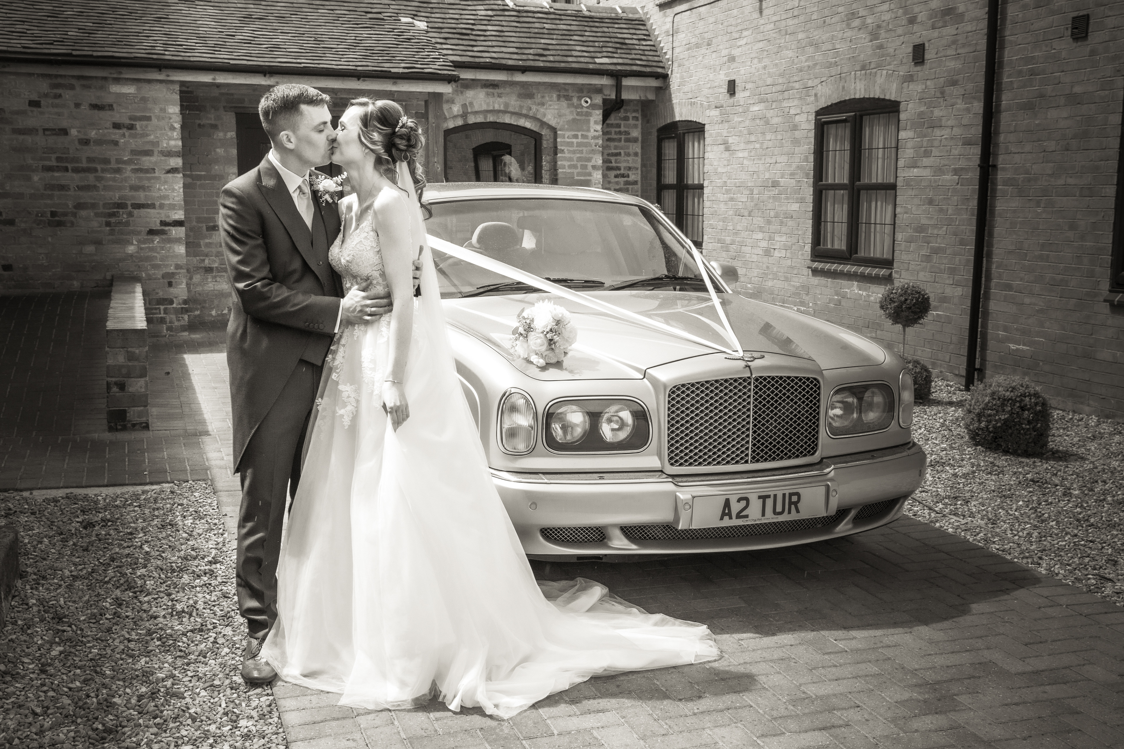 Bride and groom with their wedding car by The Multi Media Market Wedding Photography.